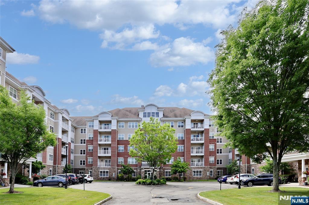 More than a home...it's a lifestyle! Two deeded underground parking spots, # 87 and 33, and a 6x10 deeded storage unit next door, #2C, are a few of the amenities of this 1768 SF Colfax unit in the Del Webb 55+ active adult community of Wanaque Reserve. Some other great things about this home is that it is next door to the 20,000 SF clubhouse...the indoor and outdoor pools, cafe, exercise room and the more than 45 clubs and activities, as well as a gatehouse which provides 24-hour security. The home features a living room with sliding doors, which open to a private balcony, dining room, den/home office with French doors, adding a touch of elegance, eat-in-kitchen with plenty of cabinets and pantry, laundry room off the kitchen, primary bedroom ensuite with tray ceiling, walk-in-closet and another closet, full bath with walk-in-shower, double vanity and private toilet room, 2nd bedroom, and full bath. Some of the clubs and activities include the travel club (four or five trips as well as several casino trips each year), tennis, pickleball, canasta, mahjong, poker, ballet, art classes, etc. Wanaque Reserve offers a luxurious lifestyle for its residents with a focus on modern amenities, security, and a sense of community. The recent renovation adds a fresh and updated living environment.