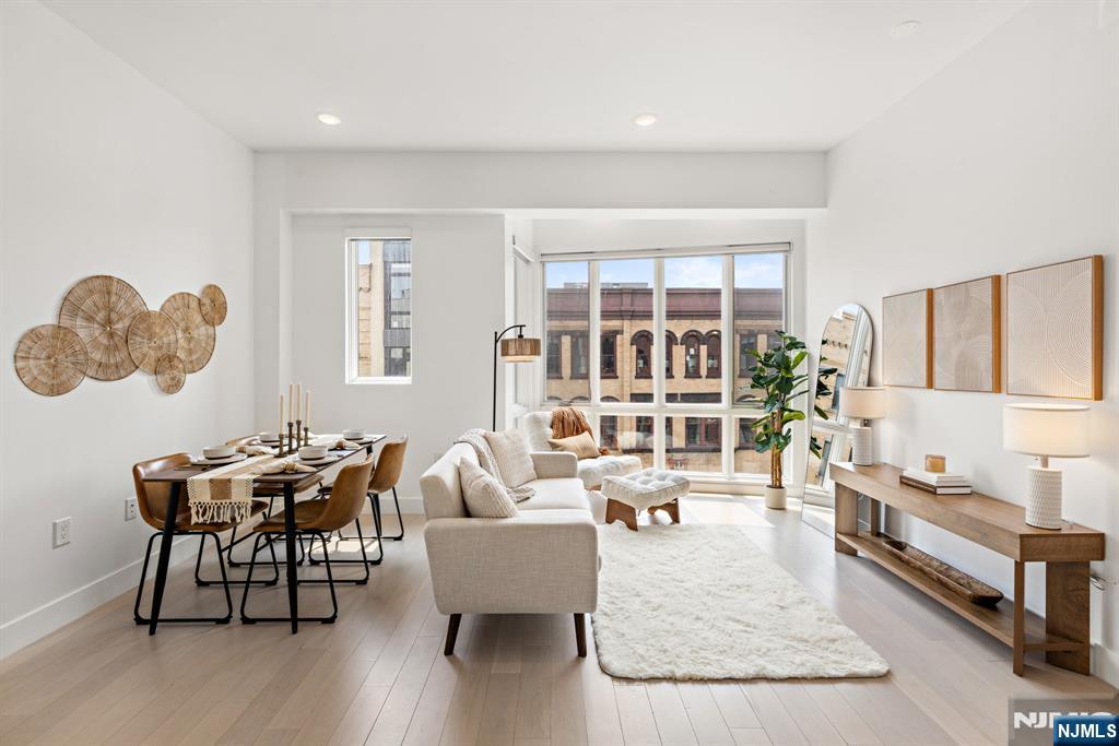 Welcome to the Cornerstone Lofts, a boutique condominium building in the heart of Downtown Jersey City. This 1-bedroom, 1-bath home features 10-foot ceilings, floor-to-ceiling windows, abundant natural light, automatic blinds, central air, and an in-unit washer/dryer. The kitchen is finished with custom-designed lacquer cabinetry, quartz countertops, and a fully vented hood, with an open layout that makes the space feel modern without being overdone. The building offers a private rooftop gym with a Peloton, plus a rooftop terrace with grills, a fire pit, a turf lounge area, and NYC skyline and Hudson River views; perfect for hosting or relaxing outdoors. Parking is available adjacent to the building. Located just minutes from Grove Street PATH, restaurants, cafes, shops, and nightlife, this home offers luxury, convenience, and quick access to NYC from Jersey Cityâ€™s most desired neighborhood.