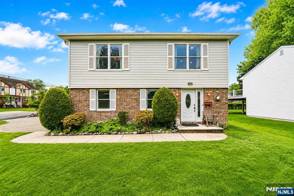 Amazing opportunity to own a spacious home with a summer kitchen in desirable Northvale. 4-bedroom, 3- full bath residence is ideally located near parks, shopping, and within walking distance to Northvale Public School, with convenient access to major highways and NYC transportation. Set on a wide, beautifully landscaped lot, the property features a long paver driveway with a 2 car garage, and a large covered patioâ€”perfect for outdoor dining, entertaining, or relaxing in a private setting. Inside, the home offers a well-maintained layout, highlighted by warm wood accents and a practical multi-level design. The first level includes a spacious family room, a second kitchen (summer kitchen), a bedroom, a full bathroom, laundry room, and direct access to the garage. Sliding doors lead out to the covered patio with a skylight, creating seamless indoor-outdoor flow. The upper level features hardwood floors throughout and opens to a bright, multifunctional living and dining area. The main eat-in kitchen is equipped with appliances only 2 years old, and three generously sized bedrooms complete the level, including a primary suite with its own full bathroom. A solid home with great bones, generous space, and excellent potential to update and customize to your taste.