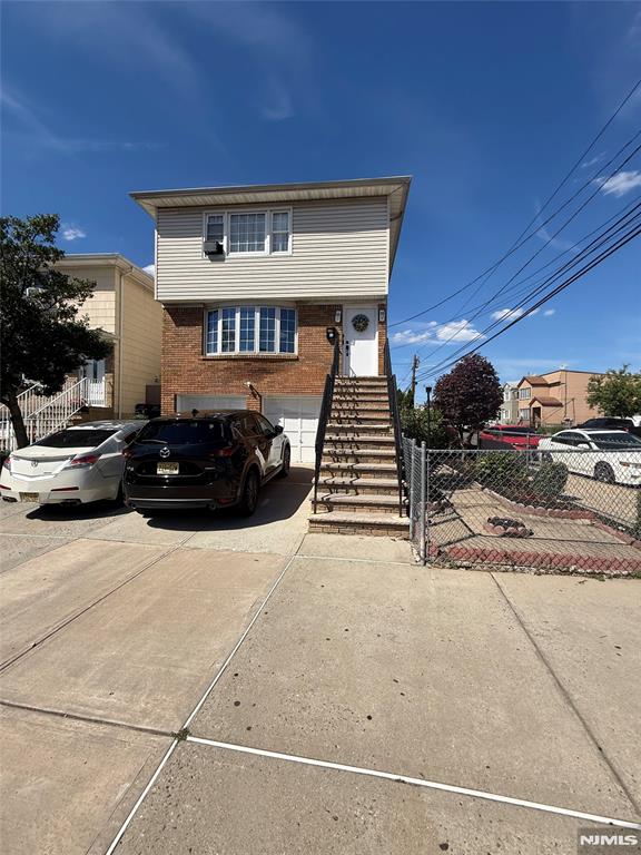 2 Family Home corner property with 2 car garage! Excellent opportunity for investors or owner-occupants! The vacant first-floor unit offers 3 bedrooms, 1 full bath, spacious living room, and formal dining room. The tenant-occupied second-floor unit features 2 bedrooms, 1 full bath, living room, and dining room. The ground level includes additional finished space with a summer kitchen, living room, 1 bedroom, and 1 full bath. Conveniently located near shopping, schools, parks, and transportation. Property being sold strictly AS IS.