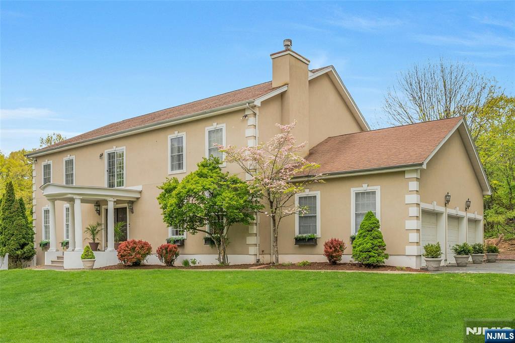 Tucked on a quiet cul-de-sac in Upper Montclair, this custom-built home offers rare space, privacy, and flexibility - minutes from the NYC direct train, top-rated Montclair Schools, Upper Montclair shopping center and Montclair's vibrant downtown. The main level features a living room with fireplace, formal dining, family room, and gourmet kitchen with dedicated prep kitchen. A sun-drenched sunroom overlooks the heated in-ground pool, deck, and patio. Upstairs, four bedrooms each have en suite baths. A sitting area at the top of the stairs makes a perfect home office or retreat. The ground level sets this home apart: two bedrooms, full kitchen, living room, dining area, full bath, and its own entrance - offering exceptional flexibility for guests, family members who value their own routine, or a live-in caregiver. A 3-car attached garage, driveway parking for six, and proximity to parks, hiking trails, tennis courts, and the Presby Iris gardens complete this truly rare Montclair offering.