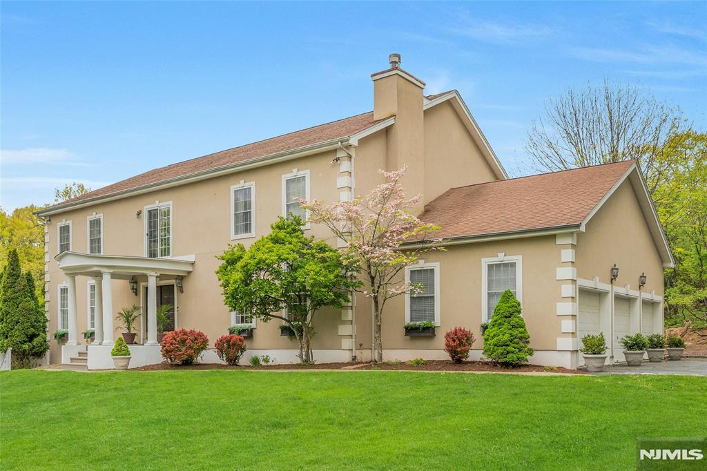 Tucked on a quiet cul-de-sac in Upper Montclair, this custom-built home offers rare space, privacy, and flexibility - minutes from the NYC direct train, top-rated Montclair Schools, Upper Montclair shopping center and Montclair's vibrant downtown. The main level features a living room with fireplace, formal dining, family room, and gourmet kitchen with dedicated prep kitchen. A sun-drenched sunroom overlooks the heated in-ground pool, deck, and patio. Upstairs, four bedrooms each have en suite baths. A sitting area at the top of the stairs makes a perfect home office or retreat. The ground level sets this home apart: two bedrooms, full kitchen, living room, dining area, full bath, and its own entrance - offering exceptional flexibility for guests, family members who value their own routine, or a live-in caregiver. A 3-car attached garage, driveway parking for six, and proximity to parks, hiking trails, tennis courts, and the Presby Iris gardens complete this truly rare Montclair offering.
