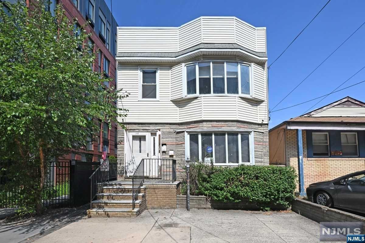 What an opportunity to purchase this sun-soaked home in Jersey City just minutes from major highway Route 9 with a nice size backyard that can used for entertainment. First floor features 2 bedrooms, large living, separate dining room, large kitchen and access to the backyard. Second floor features two (2) bedrooms, large living with arched cathedral ceiling wood bean, separate dining room, large kitchen and a balcony. Full basement has laundry area, separate utilities, heat is forced air, window a/c. Basement can be renovated for use of home office, recreation and/or family room. Take the opportunity.