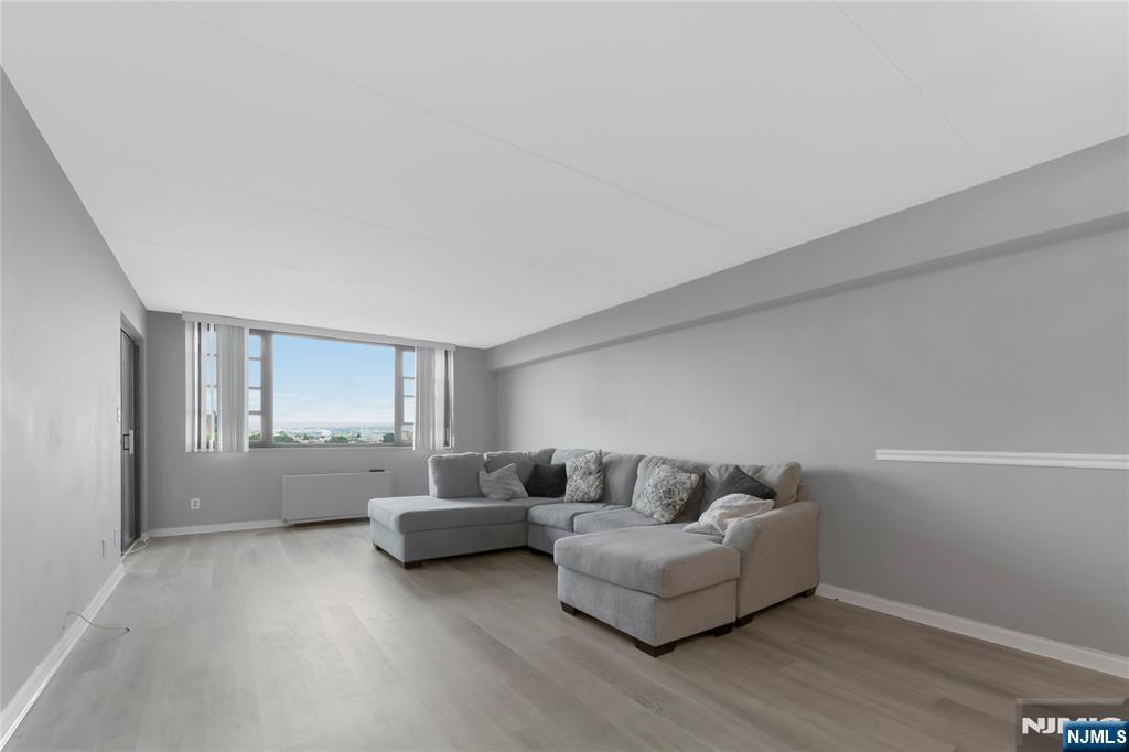 Welcome to the Apogee on the Palisades! Relax and enjoy gorgeous sunsets with direct western exposure from your private living room and terrace. This move-in-ready 1-bedroom, 1-bathroom home features a tastefully renovated kitchen and a modern bathroom with a stylish, all-in-one shower. Beautifully updated throughout, the property features a fully enclosed terrace that functions perfectly as a home office. The remarkably low monthly maintenance fee of $974 covers real estate taxes, premium cable (HBO/Showtime), 1G high-speed internet, and an incredible suite of amenities: a 24-hour doorman/security, a brand-new fitness center, yoga room, heated pool, jacuzzi, kiddie pool, BBQ area, children's playroom, community room with a catering kitchen, and a library. This building offers a fully finished parking garage complete with EV chargers. Commuting is a breeze with NYC transportation right across the streetâ€”including an express bus just 25 minutes to Port Authority and a free ferry shuttle. Enjoy ultimate convenience with proximity to Edgewater Commons, Mitsuwa, Trader Joe's, and more. Schedule your private tour today!