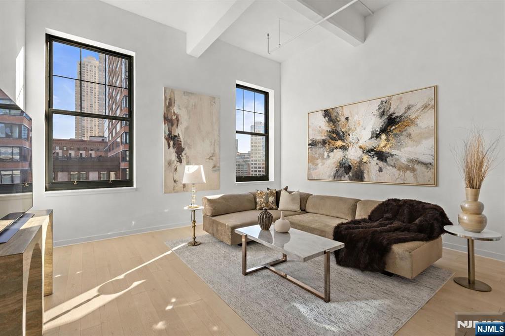 Residence 808 at 155 Bay Street is a 1-of-1 floor plan offering the finest downtown Jersey City has to offer just moments to the Grove Street PATH! Impeccably maintained, offering 2 bedrooms + den and 2.5 baths, and a rare value-add: two EV garage parking spaces plus a private storage unit. Ideally positioned within the community in a private hall near the buildingâ€™s pool, fitness center, and co-working space, this residence pairs minimalist design with elevated lifestyle - soaring 13ft ceilings, both bedrooms with en-suite bathrooms and walk-in closets, abundant kitchen space and storage plus den/office roomy enough for two. Enjoy resort-style amenities, including the 34th floor Sky Lounge and rooftop terrace with breathtaking NYC and Statue of Liberty views, 24/7 attended lobby, grills, fire pit, childrenâ€™s playroom, arcade-style game room, pet spa, dog run and more! Set in the Powerhouse Arts District surrounded by Jersey Cityâ€™s best dining, shopping, and waterfront parks, offering a seamless NYC commute and access to all major highways. A standout in one of JCâ€™s most sought-after addresses.