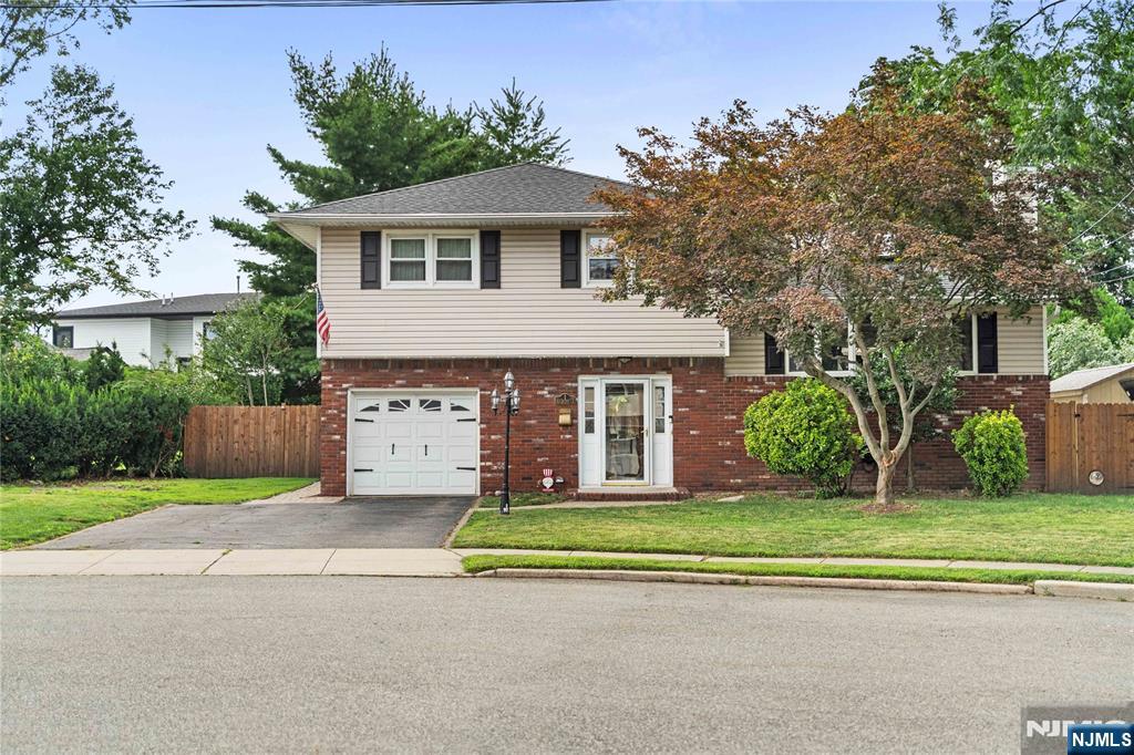 Nestled on a quiet cul-de-sac in desirable Rochelle Park, this beautifully maintained 3-bedroom, 2-bath split-level home offers over 2,250 sq. ft. of well designed living space, blending modern updates with ample indoor and outdoor living. Sun-filled interiors feature hardwood floors, recessed lighting, and an inviting open layout ideal for everyday living and entertaining. The living room flows seamlessly into the dining area, while the well kept kitchen showcases granite countertops, stainless steel appliances, and space for breakfast area. The second level offers, the primary bedroom with ensuite bath with dual access, good closet space, accompanied by 2 generously sized bedrooms. The ground level features a spacious family room, a full bath, and direct access to the attached garage, providing flexible space for guests, a home office, or recreation with direct access to oversized backyard. A large partially finished basement offers endless possibilities for storage or future expansion. Step outside to your private backyard oasis featuring a maintenance-free deck, paver patio, fully fenced yard, and plenty of space for outdoor entertaining. Conveniently located near shopping, dining, parks, major highways, and NYC transportation, this move-in-ready home perfectly balances suburban comfort with commuter convenience. Annual taxes: $10,709.10. Call us today for a private tour!