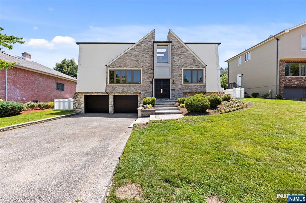 FULLY RENOVATED LUXURY HOME ON A QUIET,PRIVATE STREET W WHITE FENCE. BRAND NEW ROOF,FRESH FACADE,FRESHLY PAINTED INSIDE AND OUT, PROFESSIONALLY LANDSCAPED W NEW TREES,FLOWERS, STONE STEPS.THE CURB APPEAL IS INSTANT.FIRST FL FEATURES BRAND-NEW FLOORING IN FOYER,DINING RM,AND KITCHEN,W REFINISHED HARDWOOD & NEW RAILING THROUGHOUT THE ENTIRE HOME.GRAND LIVING RM W CHAIR MOLDINGS,COZY FAMILY RM W FIREPLACE AND GLASS WALL OVERLOOKING OVERSIZED DECK,FORMAL DINING RM W PANTRY, AND GOURMET EAT-IN KITCHEN W THERMADOR APPLIANCES,FARM SINK,AND QUARTZ ISLAND.MASTER SUITE OFFERS TWO RMS,CALIFORNIA CUSTOM WALK-IN CLOSET RM,AND SPA BATH WITH GLASS SHOWER,JACUZZI TUB,AND DOUBLE VANITIES W SKYLIGHTS.TWO LARGE BEDRMS W WALKIN CLOSET,HALLWAY CLOSET RM,LINEN CLOSET.GROUND FL OFFERS TWO BEDRMS,CEDAR CLOSET RM,FULL BATH,LAUNDRY RM W WINDOWS.OVERSIZED TWO CAR GARAGE W STORAGE RM.OVERSIZED DECK FOR BBQ AMD ENTERTANING.ALL SURROUNDED BY WHITE FENCING FOR PRIVACY.MOVE-IN READY IN ONE OF BERGEN COUNTY'S MOST PRETIGIOUS COMMUNITIES.TOP-RATED SHOOLS AND EASY NYC COMMUTE.