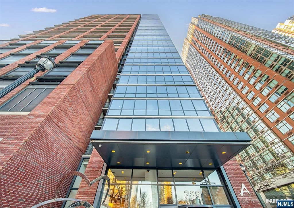 Indulge in panoramic views of NYC's skyline from floor-to-ceiling windows in this 2-bed, 2-bath, 1366-sq ft condo. Light-filled living spaces complemented by 9' ceilings & oak hardwood floors. Gourmet kitchen w/maple shaker-style cabinets, granite countertops, & SS appliances featuring a Bosch dishwasher. Delight in cozy sunrises & dazzling sunsets on the intimate balcony overlooking the Hudson. Spacious primary bedroom boasts a generous walk-in closet. Marble primary bath complete w/full-length soaking tub, stand-up shower, & double sink vanity. In-unit W/D & 1 deeded parking space. 4 gas-powered PTAC units individually controlled by Nest thermostats & thermal insulated Low-e glass windows for energy efficiency. Elevated building amenities: 24-hr concierge, gym, lounge, outdoor deck with BBQs, & childrenâ€™s playroom. 5 to 10-min walk to all 3 JC PATH, NYC Ferry Terminal; surrounded by a foodie paradise of award-winning global eateries & quaint cafes. Experience JC living at its finest.
