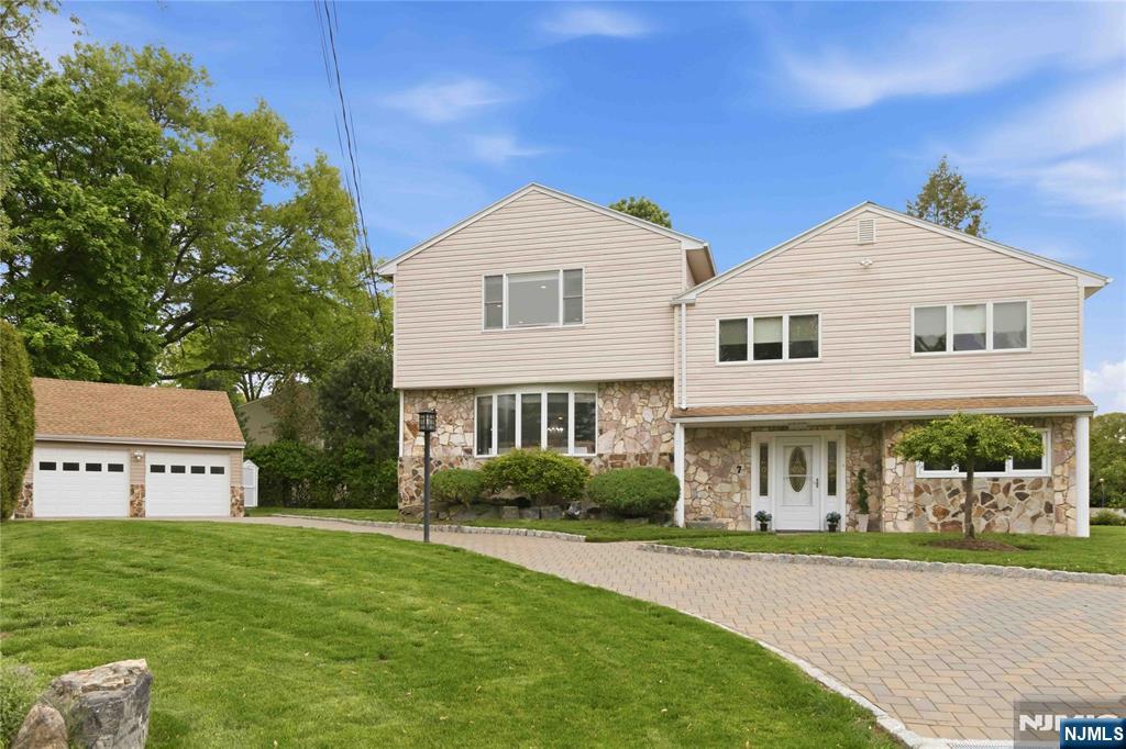 Tucked away on a quiet cul-de-sac, this lovingly maintained expanded split-level home offers nearly 3,000 sq ft of comfortable living space with a flexible layout ideal for todayâ€™s lifestyle. A marble-tiled entry leads to a spacious family room with sliding glass doors to the backyard. A private office, powder room, and access to the finished basement complete this floor. A half flight up either by the entrance or by the family room, is the open-concept main living area designed for both everyday living and entertaining, featuring a sun-filled living room, dining room, and kitchen anchored by a wood-burning fireplace with marble surround. Rich dark walnut flooring flows throughout this level and the bedroom level. The kitchen is appointed with paneled Sub-Zero refrigeration, dishwasher, and gas range. The second level offers a renovated hall bath, two generously sized bedrooms, and a former primary bedroom with walk-in closet and private bathroom.. The entire third level is the expansive primary suite retreat with a sitting area, office nook, wall of closets, and a spacious primary bath with double vanity, soaking tub, and separate shower. The finished basement provides space for recreation, storage, laundry, and utilities. Home comes with a two-car garage with epoxy flooring and two separate storage/tool sheds. Located in a sought-after town known for its excellent schools, this special home combines space, functionality, and warmth in a peaceful neighborhood setting.