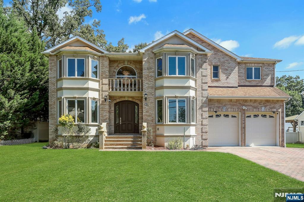 Taxes shown in Zillow is wrong. This beautiful house features 4 large bed, 4.5 bath, a well-appointed bright kitchen with granite counter tops, stainless steel appliances and tons of cabinets, an inviting formal dining room with French door, living room, family room with a cozy gas fireplace, coat closet, half-bath and breakfast nook all designed for seamless living. Enjoy the warmth of first floor and second floor rooms all with hard wood floors, crown molding and 4 bay windows facing front which bring abundant natural light to the home. New porcelain matt tiles laid out from entry foyer to the kitchen and to the half-bath add extra charm to the first floor.Step out onto the breath-taking tiled spacious patio complimented with beautiful balustrades, perfect for enjoying peaceful mornings or evening or entertaining guests creating endless possibilities for outdoor enjoyment. Gorgeous backyard is complete with an underground sprinkler system lawn, paver walkway and gas hook up for outside cooking. Upstairs, you will find an oversized master bedroom with a massive walk-in closet. The primary bath, which has new porcelain tile floor laid out in June 2025 features a walk-in glass door standing bath, jetted jacuzzi, dual vanities with marble countertop and a large closet. There are 3 additional bedrooms, each with ample closet place and two additional impeccable full baths and a laundry room. Full finished basement has a full bath & Central Vacuum System. Near to NY transportation