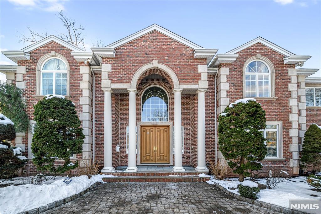 Elegantly designed Center Hall Colonial showcasing exceptional craftsmanship and impressive scale throughout. A dramatic two-story entry foyer features marble flooring with radiant heat and opens to a professionally designed interior, including a soaring two-story living room with fireplace. Custom moldings and quality hardwood floors enhance the homeâ€™s refined character. The oversized, state-of-the-art eat-in kitchen is equipped with custom cabinetry, granite countertops, a center island with sink, top-of-the-line appliances, a spacious breakfast area, butlerâ€™s pantry, and built-in desk space. Sliding glass doors lead to a private backyard with paver patio, ideal for indoor-outdoor entertaining. The expansive finished basement offers a wine bar and private theater, creating an exceptional space for entertainment and relaxation. The luxurious primary bedroom suite features a fireplace, walk-in closets, and a spa-like primary bath complete with wet spa, steam shower, jetted Jacuzzi tub, dual vanities, and bidet. Additional highlights include five-zone air conditioning, sixteen-zone heating, central vacuum, intercom system, and meticulous attention to detail throughout. Offering over 8,000 square feet of gracious living space, this exceptional residence is ideally located in the highly desirable North Cliffs section of Englewood Cliffs.