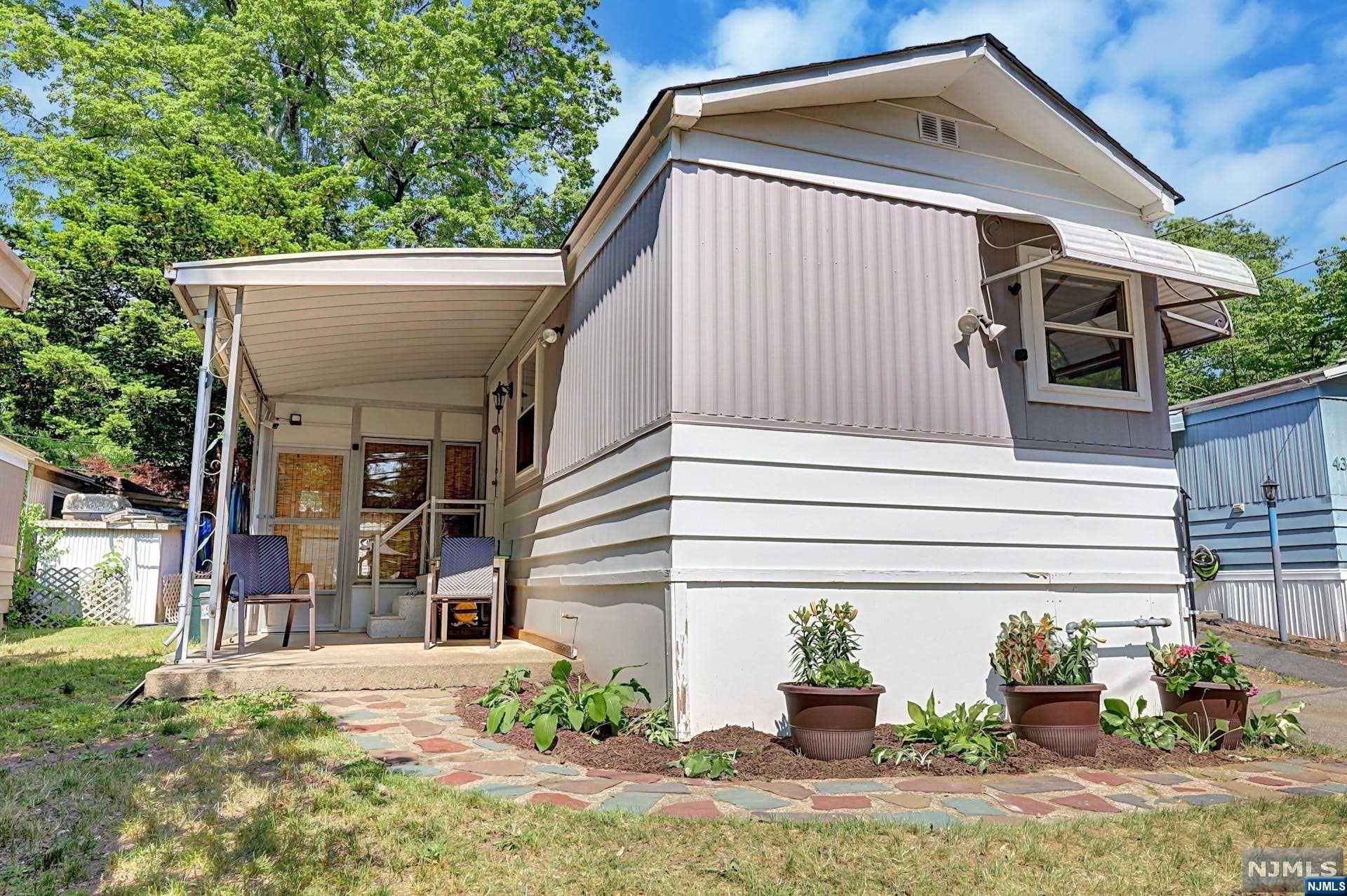This absolutely adorable, affordable mobile home was completely taken down to the studs and rebuilt in 2017.Owner spared no expense when rebuilding. Halcyon Fujitsu Heat pump/ac system, Rinnai Tankless on demand hot water system. Whole house water filter. 30 Amp gas generator. High hat lighting throughout. Surround sound wiring in place, new roof and windows, new plumbing, electric and panel. Large eat in kitchen with marble counters and subway tile backsplash. Nice sized bedroom with bath/closet/laundry. Screened in three season porch and covered patio. Current Monthly maintenance fee of 810, covers water, sewer, taxes, garbage removal, snow removal in common areas. Storage shed. Bogarts ranch community is the best kept hidden secret in the area, surrounded by much higher priced homes. Financing options available.