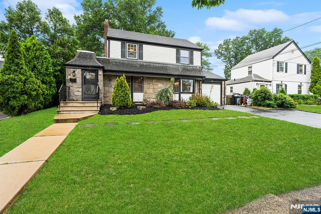 Expanded Colonial in One of River Edge's Most Desirable Neighborhoods. Welcome to this beautifully expanded Colonial, perfectly situated in one of River Edge's most sought-after neighborhoods. Move-in ready and thoughtfully updated, this home offers the ideal blend of timeless charm, modern comfort, and functional living spaces. The first floor welcomes you with a spacious entry foyer featuring generous closet space. The bright and inviting living room showcases a stunning stone fireplace and flows seamlessly into the home office, family room, dining room, and a beautifully appointed eat-in kitchen. Designed for both everyday living and entertaining, the kitchen features stainless steel appliances, an island, and overlooks the sun-filled backyard. A full updated bathroom, convenient laundry area, and direct access to the attached garage and to the backyard complete the main level. Upstairs, you'll find three generously sized bedrooms, an updated full bathroom, and an impressive primary suite featuring a large walk-in closet and a luxurious en-suite full bath. Additional highlights include hardwood floors throughout, a finished basement offering abundant recreation space and storage, and exceptional outdoor living. Enjoy outstanding curb appeal, a spacious patio ideal for entertaining, and a large private backyard. Conveniently located near top-rated schools, parks, shopping, and transportation, this turnkey home truly has it all. Simply unpack and move right in!
