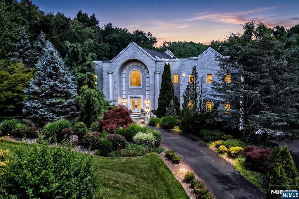 Prepare to be impressed! Drawing from the natural beauty of its surroundings, this spectacular custom-built estate is perfectly placed on 2.8 magnificent, lush private acres. Located in the prestigious, sought-after area of Burning Hollow, w/excellent supporting values, this incredible manor has it all! From the circular drive w/lovely free-form pond and falls, step through the attractive leaded-glass doors onto an expanse of polished marble flooring to find a breathtaking, lofty space. Illuminated w/natural light from 8 skylights, the LR features 2 story soaring ceilings and floor-to-ceiling marble FPL. Open to the DR, den, and bar, this commodious area is ideal for large-scale entertaining. Experience over 10K SF of luxury living at its best w/a gourmet kitchen w/FPL and grand MBR w/private terrace, his-and-her walk-in closets, and baths! Enjoy the view from the fabulous free-floating balcony, and the convenience and appeal of an elevator, back staircase, and 10' ceilings on all 3 levels. Decking leads to the beautifully landscaped, gated, oversized rear grounds, which easily accommodate both the sparkling in-ground pool and tennis/basketball court. Along with its 4-car attached garage and municipal water, it is truly a rare find. Located minutes from NYC, major routes, shops, and fine dining, Saddle River offers its residents majestic homes and rural beauty, along with highly rated schools and low taxes. You will not want to miss this exquisite estate. Opportunity knocks!