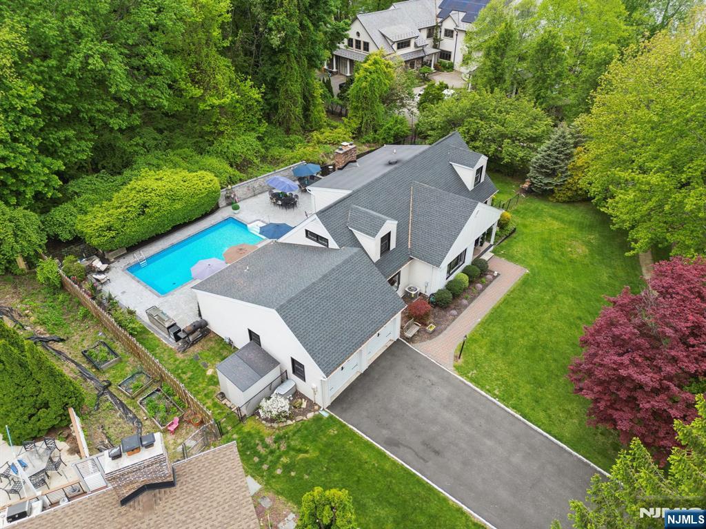 Welcome to this newly renovated home that offers luxury lake living with a heated inground pool flawless designer kitchen with stunning granite island and first floor primary ensuite. Set on a cul de sac of premeire homes, the exterior has been completely redesigned with modern farmhouse details including new paint, windows, doors and new roof. The back yard is a private oasis that features an exceptional stone paver block patio with beautiful heated saltwater pool and outdoor barbeque area. Inside is the perfect blend of traditional and modern living with an open floorplan and large rooms. First floor has grand entrance, living room,dining room, family room with woodburning fireplace, eat in kitchen, mud room, 2 powder rooms, laundry room, 2 car garage and a primary ensuite with bedroom, walk in closet and full bath with jetted tub. Second floor has three large bedrooms, each with walk in closet and spacious main bath. Basement has gym, recreation room,storage and outside entrance. This home provides wonderful spaces for entertaining including a massive designer kitchen with 8 burner italian stove with double oven, pot filler and commercial grade hood vent, top of the line refrigerator, dishwasher, microwave, and custom wet bar with beverage refrigerator and a stunning oversized center island that seats 8 with granite top, sink , and extra under cabinet storage. Enjoy all Lake Hopatcong has to offer including motor boats, beaches, kayaking, fishing and fine dining.