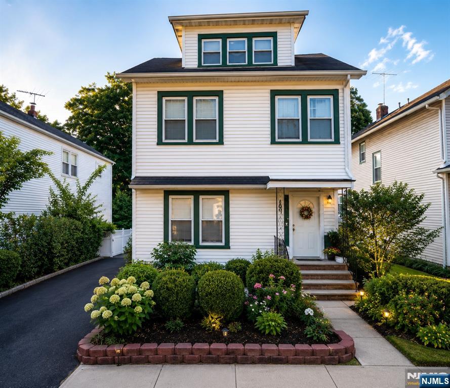 Beautiful and spacious two-family home with a bonus located in Montclair, NJ, featuring hardwood floors throughout and separate utilities. The first-floor unit offers 2 bedrooms, 1 full bath, a living room, dining room, office space, and kitchen. The second unit spans the second and third floors with 3 bedrooms, a sunroom, living room, dining room, a full bath, and a modern kitchen with sliding doors that open to a private deck overlooking the backyard. The finished basement includes a full bathroom, three additional rooms, and a separate entrance to the utility room with two water heaters and two house heating systems. Enjoy the serene backyard with a koi pond, patio, a two-car detached garage, and a driveway that fits four cars. Conveniently located within walking distance to shops, parks, schools, public pool, and transportation.
