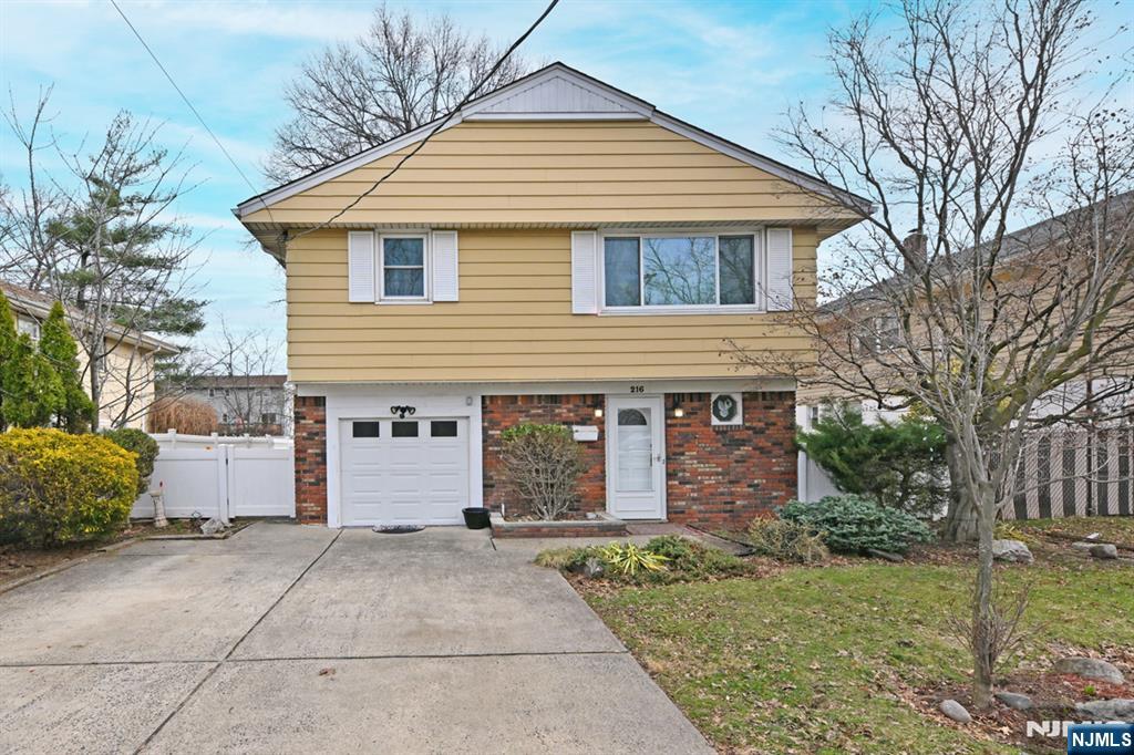 Immaculate, deceptively large home in quiet neighborhood of desirable Little Ferry , NJ. Over 2,000 sq ft, with all large rooms including large entry foyer, open living rm/dining rm combo, eat-in kitchen, 3 good size BRs including King Size Primary BR. 2 Updated Full Bathrooms! Additional features include Newer Roof, New Hot Water Heater, Central AC, hardwood flrs, attached garage plus double wide driveway for 4 cars, freshly painted and low taxes! All this plus a huge, fantastic ground floor Rec Room/ Family Rm or could even be a massive Primary Suite as it has the second full bathroom! New PVC Fenced Backyard with patio and BBQ Gas Line ready for your upcoming Spring and Summer gatherings! Also has tranquil pond and park across the road for your neighborhood enjoyment! Close to shops, restaurants & NYC Bus. Move in Ready ! Dont miss this one!