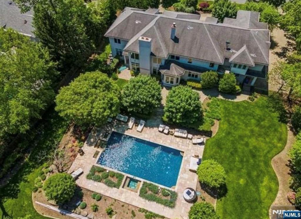 Built to the highest standards, this elegant 6 bedroom, 6.1 bath Colonial sits atop Tenaflyâ€™s prestigious East Hill. A circular paver driveway and grand two story entry with travertine floors welcome you to this exceptional home. The main level offers formal living and dining rooms, a dramatic two story family room with stone fireplace and floor to ceiling windows, and a gourmet kitchen with breakfast area and butlerâ€™s pantry. A first floor bedroom with backyard access and a fully renovated wet bath that also serves as a cabana bath adds flexibility. The primary suite features an oversized walk in closet, balcony, sitting area with fireplace and spa like bath with radiant heated floors. Three additional en suite bedrooms complete the second floor. The finished basement with high ceilings includes a theater, recreation area and two additional bedrooms. Beautifully landscaped property with resort style pool, spa, patios and built in BBQ.