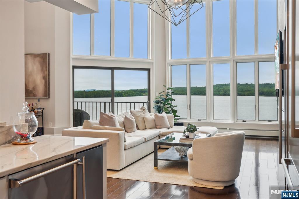 One-of-a-Kind Penthouse in Wayne! Incredible water views, top of the line finishes, & sleek ,modern, minimalist architecture come together in this show-stopping luxurious property. This is truly the only residence of its kind in Wayne, blending the elegance of Manhattan with the comfort of Wayne. Enjoy the perks of a doorman, a rare and coveted feature outside of the city, plus exceptional amenities...pool, gym, tennis, rec room, enclosed parking, and a private storage room.When you walk through the traditional penthouse double doors, you will be stunned with the dramatic floor-to-ceiling wall of windows, filling the space with natural light and framing breathtaking views of the reservoir. It stops you in your tracks when you see this view. High ceilings and open-concept layout features a dazzling living room with modern fireplace and custom built-in floating shelves. A chef's dream kitchen with high-end cabinetry, ss appliances, and oversized center island that flows seamlessly into the dining area perfect for entertaining. Step out onto your private balcony to experience non restricted water views that feel like a retreat. Upstairs, the primary suite offers a serene escape with a newly renovated bathroom, custom closets, and pool/tennis court views. An open loft with fireplace and additional bedrooms, and a stunning main bath complete the upper level. Additional features include gleaming hardwood floors, custom pantry, laundry room, and a whole-home surround sound system.