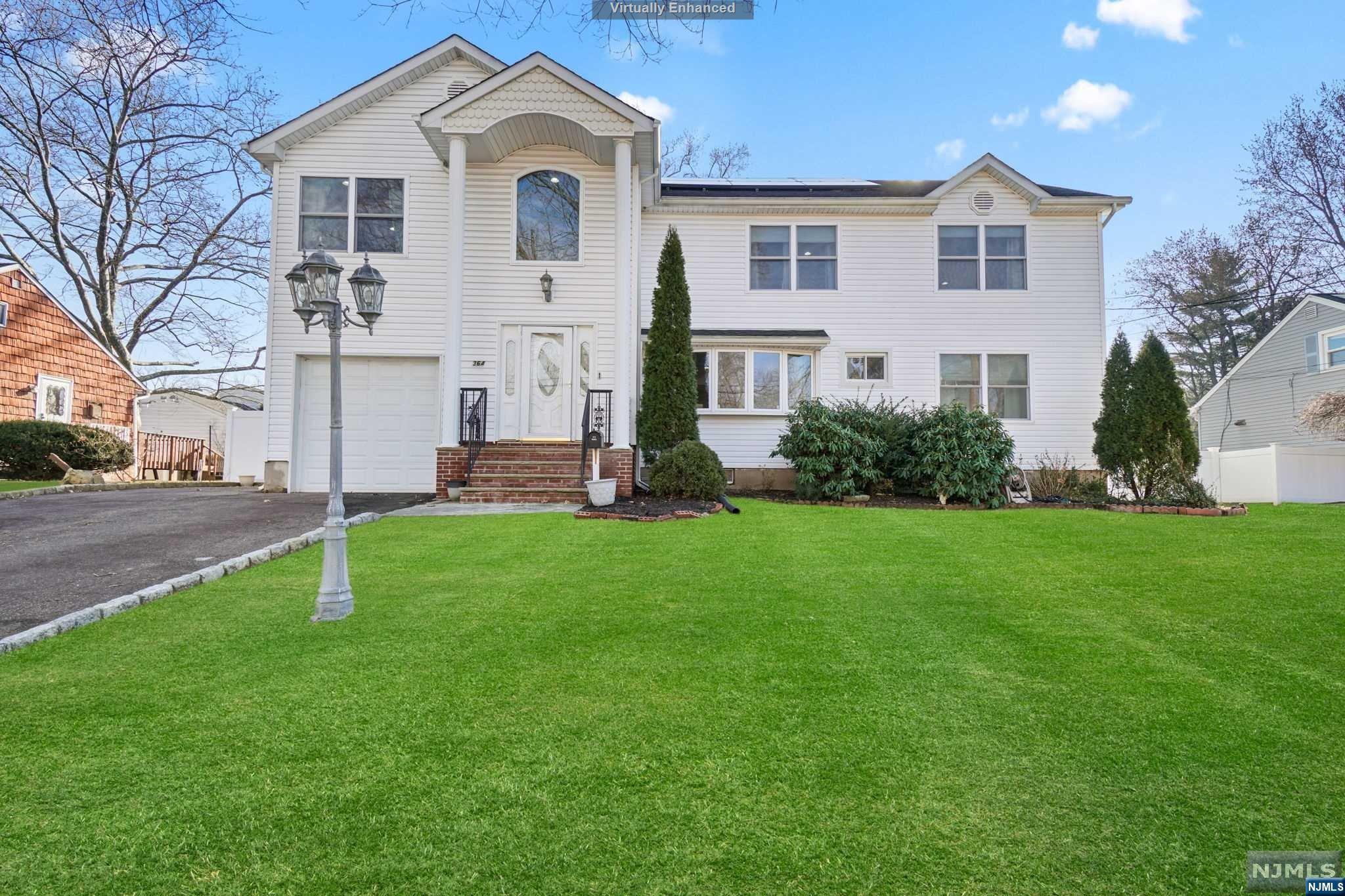 Move right into this exquisite colonial nestled on a tranquil, tree-lined street in desirable New Milford. Feat 5 beds, 4 full baths, an expansive finished basement, attached garage, and private backyard designed with outdoor entertainment in mind. Enter and you're greeted by a stunning living room with a 2-story ceiling, gleaming hardwood, and an abundance of natural light. The dining room is the focal point of the main floor, w easy access to the modern eat-in kitchen boasting dark wood cabinetry, stainless steel appliances, and a large breakfast bar island, + a generously sized family room with windows on every wall. The 2nd fl is truly fit for family w/ 3 beds, 2 full baths, a charming reading nook loft, and bonus space perfect for playroom, study, or workspace. Lower level feats; full bath, immense rec room w/ built-in bar, ample stow-away storage, and endless possibilities. Too many modern upgrades to list! Hurry - this won't last!