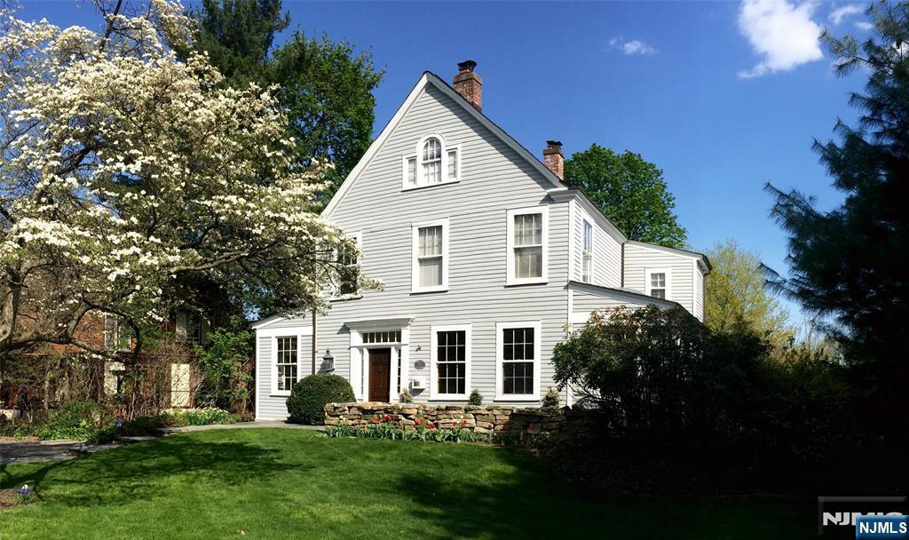 Bathed in beautiful southwest light and set on a prominent corner lot, this remarkable 1888 Victorian farmhouse offers the perfect balance of historic charm, modern comfort, and an exceptional blend of indoor/outdoor living. Known for its appearance in more than twelve national commercials, the home is beloved for its gracious proportions, soaring 12ft ceilings, open flow, and sun-filled interiors. The heart of the home is the beautifully renovated kitchen, where skylights illuminate abundant Parsons cabinetry, expansive counter space, a charming seating nook, granite countertops, a Viking range, and a Sub-Zero refrigerator. A practical mudroom and semi-finished basement add flexibility and functionality. The primary suite features a fireplace, WIC, and luxurious bath. Flexible third floor space with bedroom, bath and laundry. Step outside to discover a backyard designed for unforgettable entertaining. The landscaped grounds feature an inground pool surrounded by Vermont quarry granite decking, a tranquil koi pond, and a custom clubhouse built by the current owner. Recent upgrades include replacement of AC units, freshly painted interiors. Perfectly positioned between both Glen Ridge and Bloomfield Midtown Direct train and central to all top-ranked public schools, this is a rare opportunity to own one of the area's most iconic and admired homes.