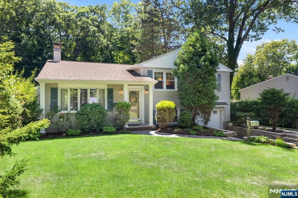 Charming 4BR, 2.5BA Split-Level Home with Extended Family Suite in Oakland's Desirable Dogwood Section! Situated on a beautiful property with wonderful curb appeal, this versatile home offers a spacious floor plan, gleaming hardwood floors, and a warm, inviting Living Room with a fireplace. The updated Kitchen features granite countertops, a peninsula with seating, stainless steel appliances, and a skylight that fills the space with natural light.The upper level includes three generously sized bedrooms with hardwood floors and ample closet space, along with a beautifully renovated full bath. A standout feature of this home is the private extended family suite off the main area, complete with its own entrance, Bedroom, full Bath, Living Room, and Kitchenetteâ€”making it ideal for multi-generational living, guests, or a private home office.The lower level offers a spacious Family Room, convenient half Bath, laundry room, direct access to the backyard, and an attached one-car garage. Step outside to a lovely, private backyard with a patio, offering the perfect setting for entertaining, gardening, or simply relaxing.Conveniently located near top-rated schools, parks, shopping, dining, and major commuter routes, this exceptional home combines comfort, flexibility, and an outstanding location.
