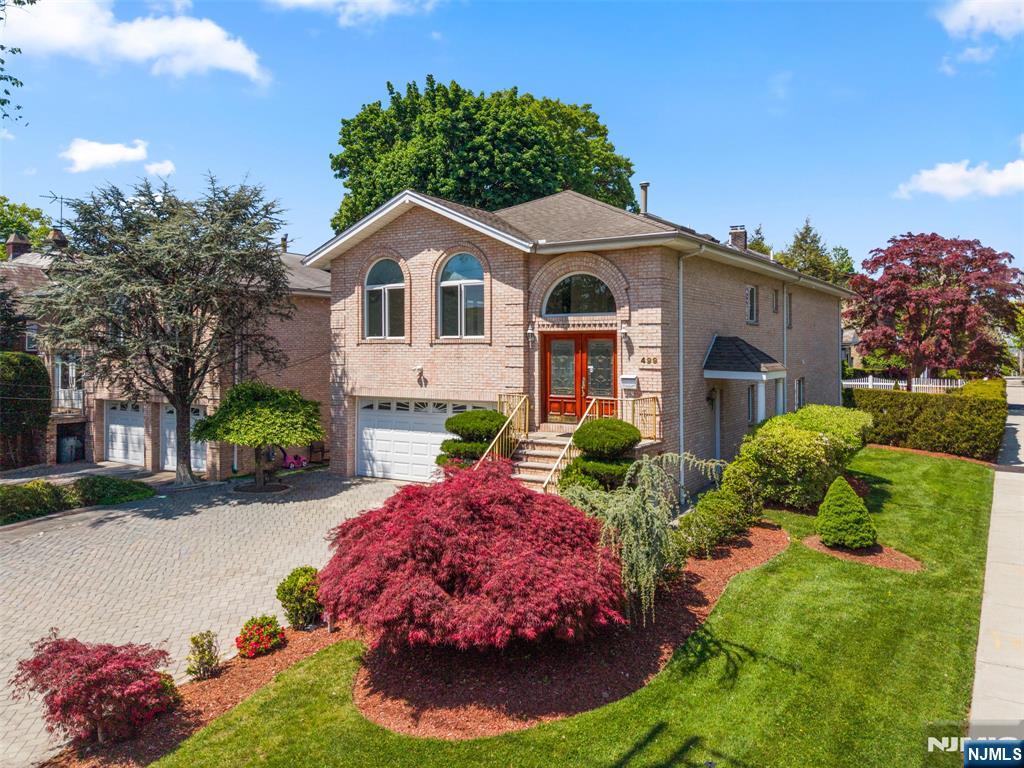 Welcome to this exceptional oversized bi-level home, perfectly designed for extended family living with an ideal blend of space, comfort, and elegance. Impeccably maintained and filled with natural light, this stunning residence features skylights throughout, beautiful hardwood floors, and an inviting layout perfect for both everyday living and entertaining. The main level offers a modern eat-in kitchen, formal dining room, and a spacious living room with an airy, open feel. The primary suite includes a private full bathroom, while two additional generously sized bedrooms, a second full bath, and a conveniently located laundry area complete the upper floor. The expansive lower level provides incredible flexibility, featuring a second eat-in kitchen, formal dining room, oversized living area, additional bedroom, full bathroom, and a second laundry area â€” ideal for multi-generational living, extended guests, or a private living space. Step outside through sliding glass doors to a beautifully landscaped backyard and patio, creating the perfect setting for relaxing or entertaining outdoors. Additional features include a spacious two-car garage, multi-zone central air conditioning, abundant storage, and exceptional pride of ownership throughout. Located in a highly desirable neighborhood, this move-in ready home offers the perfect combination of functionality, warmth, and modern living. Ridgefield also offers an in town pool minutes away!
