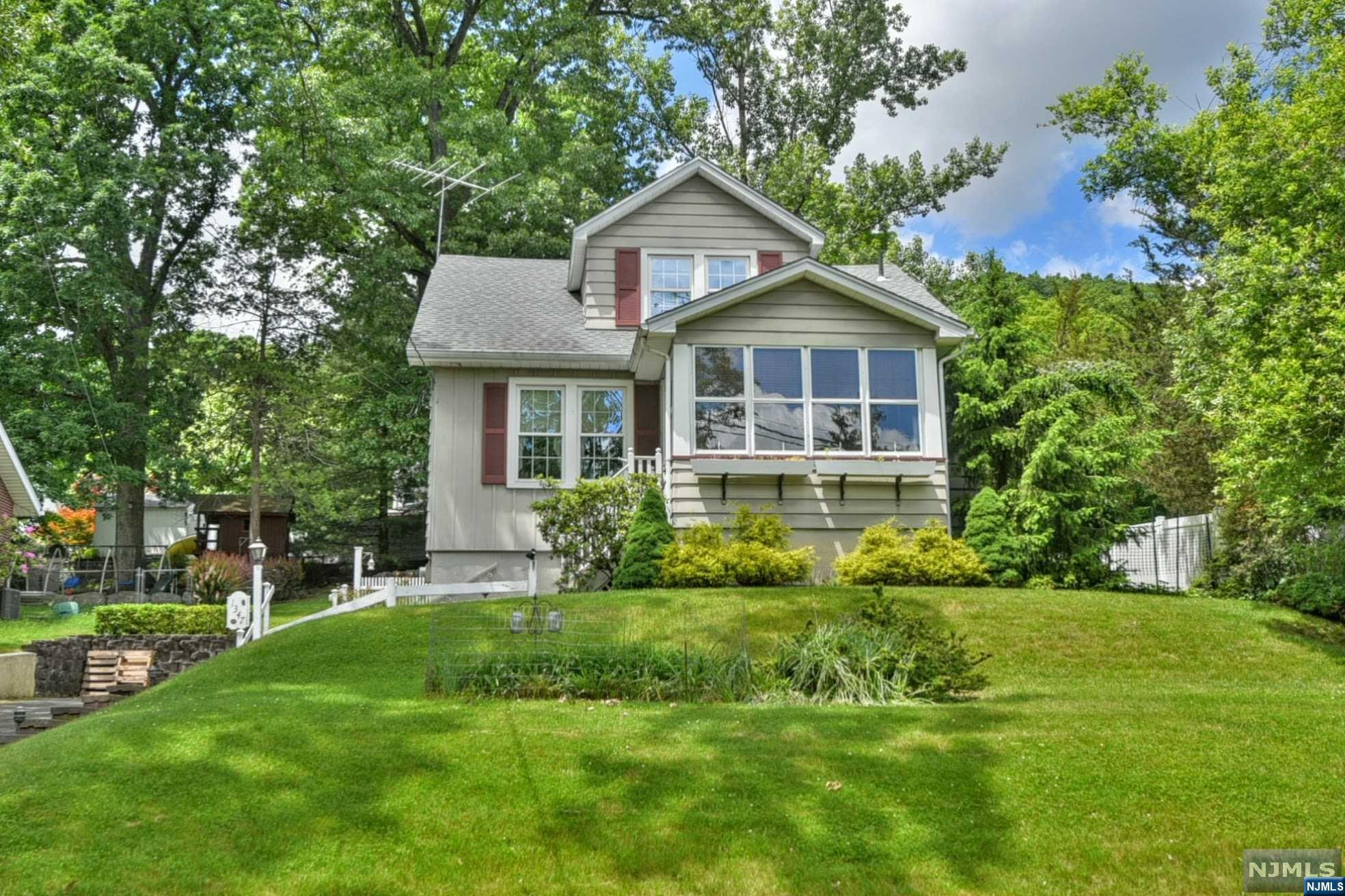 Welcome to this lovely 3 bedroom home in North Haledon! Lovingly maintained by the current owner for over 60 years, this house is sure to please. The first floor features an enclosed front entrance porch, foyer & huge foyer closet, large living room, formal dining room, kitchen, family room, sun room with sliding door to the deck, bedroom, and full bathroom. The staircase to the second floor reveals 2 large bedrooms- (both with double closets) and a light & bright home office space with storage areas in the eaves. The full basement is unfinished- features workshop, utility area, laundry area, and an attached 1 car garage with additional storage space. Other features of the home include hardwood floors on the first floor, & mini split a/c units on 1st floor. The exterior of the home features a private rear deck overlooking the rear yard offering tremendous privacy. Perfectly priced, come see this beautiful home today! :)