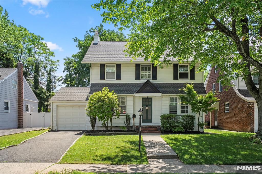 Unbeatable Location & Commuter's Dream! Welcome to this meticulously maintained Colonial on a beautiful tree-lined street. The first floor boasts a bright, airy living room with a cozy fireplace, a formal dining room with built-ins, and an updated, sun-filled eat-in kitchen and powder room with seamless access to a lovely backyard and patio. Upstairs, the second floor hosts three good-sized bedrooms and an updated full bath. A high-ceiling attic can be converted into a bedroom/office/lounge area! This home features a partially finished basement with laundry. Minutes from top-rated schools, parks, shopping, major highways (GWB, Rt 4/80/95), and NYC buses.