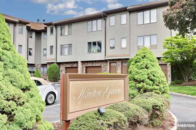 ****OWNER OCCUPIED complex only as only 1 unit in complex is allowed to be rented out and thats taken. ****PETS ALLOWED HERE*** Wonderful oppty to own a big townhouse near all esp trans to NY and malls. Beautiful hardwood floors thruout. Familyroom on main ground floor is currently being used as a bdrm with 3rd fbth and a small living room area w/sgd to fenced in backyard. Laundry in ground floor included in sale. Unit has 1 outside garage parking spot. Current owner bought w/Garage used as storage only. Gorgeous sundrenched skylites in the upper stairwell and the master primary bath. THis townhouse is sold as is with no known issues. All bdrms have walk in closets with lighting sources or window in closet. Gas heat central air ready for summer cooling. XLG bedrooms.