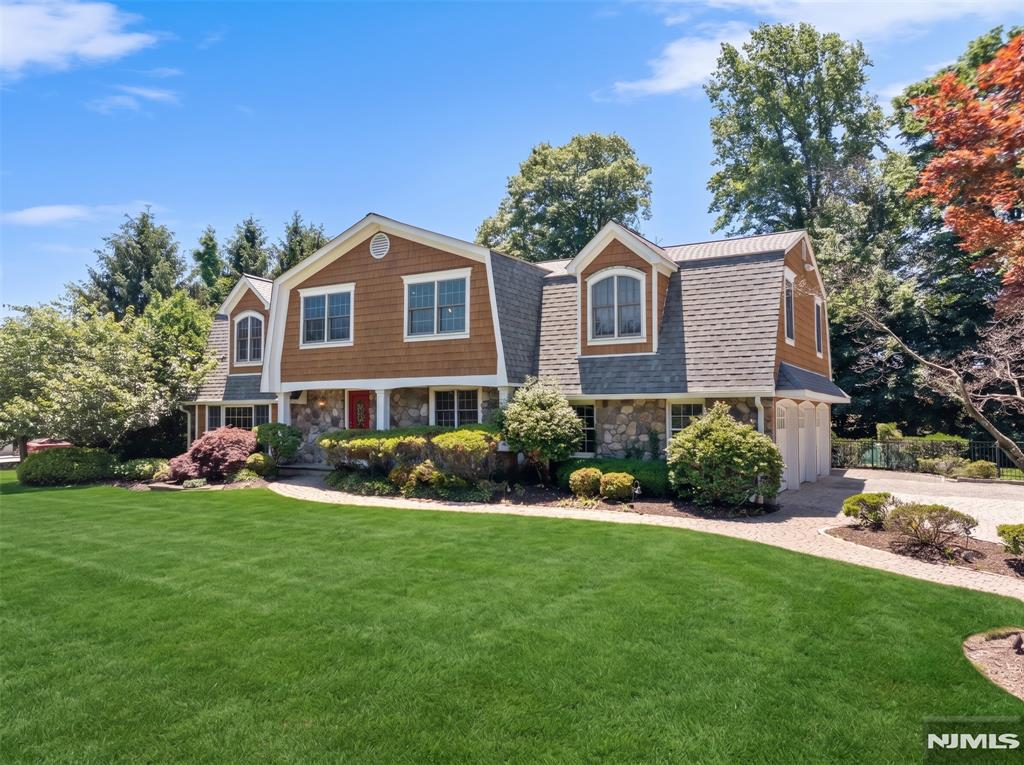 Set gracefully on a picturesque knoll on the West Hill of Woodcliff Lake, this architecturally striking custom Center Hall Colonial offers an extraordinary blend of elegance, sophistication, & modern luxury. With approximately .72 acres of beautifully landscaped & private grounds, this exceptional residence has been thoughtfully designed for those seeking an elevated lifestyle in a sought after location. Boasting five spacious bedrooms & four full baths, this magnificent residence has an open & inviting floor plan. Sunlight pours through expansive windows. The formal Living Rm & Dining Rm flow into a Family Rm w/stone fireplace. A vaulted-ceiling Sitting Rm w/skylights & a Cathedral Ceiling Great Rm showcase walls of windows that frame spectacular views of the rear property & in-ground pool. A beautifully renovated gourmet kitchen features granite countertops, Viking stainless steel appliances, & a breakfast rm. The lower level offers a Recreation Room/Media Center, a Dance Studio, & storage. The bedroom level is highlighted by an expansive primary suite that serves as a luxurious retreat featuring a spacious bedroom, a spa-inspired bath w/spacious stall shower, & a large walk-in closet. Four additional bedrooms & two full baths complete this level. A spacious 2.5 car garage w/3 bays & exceptional driveway complete this residence. The outdoor setting offers a fenced rear yard transformed into a private resort-like oasis w/heated in-ground pool, patios, & garden.