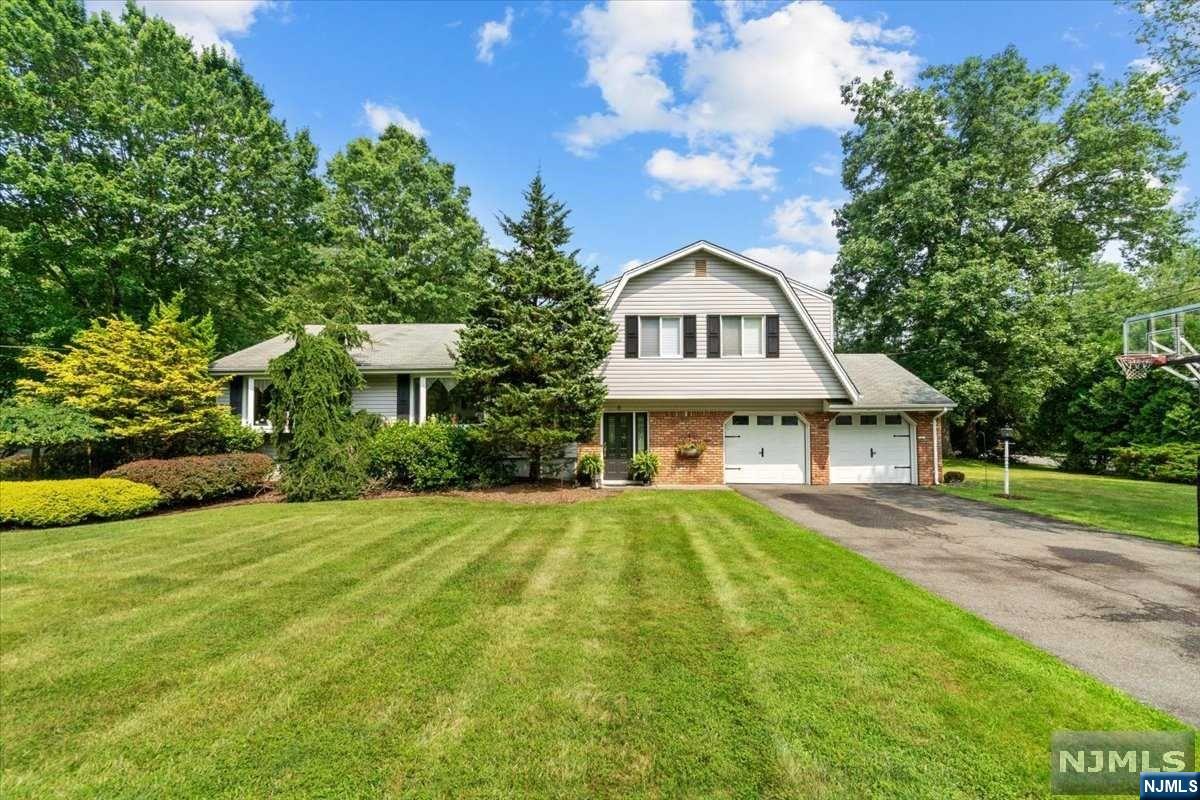 Set on one of the most desirable neighborhood streets in Ramsey this house offers 3 BR's, 3 full baths and a PRIVATE BACKYARD OASIS. On the ground level you will find a large family room, full bathroom and access to the jaw dropping yard. On the first floor, there is a huge sun-drenched LR and a stately DR. In the updated eat-in kitchen there is a stunning oversized island, high-end appliances, beautiful cabinetry and massive sliding doors opening to the yard. Moving upstairs there is an updated hall bath, 2 generous sized BR's and a large primary BR with full ensuite. On the lower level there is a beautifully finished rec room offering yet another living space. The outside features a heated pool and almost 1 acre of private land surrounded by mature landscaping. This neighborhood is truly a hidden gem and the perfect place to make your forever home! WANT MORE INFO? CONTACT LISTING AGENT NICOLE MINETTI @ 201-388-0077 or nicole@minettidennisgroup.com