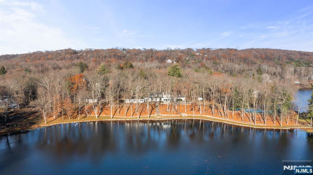 ONCE IN A LIFETIME OPPORTUNITY- A rare offering of more than 6 acres with over 600 feet of pristine lakefront on beautiful Shadow Lake. This remarkable property commands nearly the entire western shoreline of one of the communityâ€™s two connected lakes, delivering unmatched privacy, breathtaking views, and an unparalleled natural setting. Whether you choose to live in the existing residence or build a brand-new single-family home, the potential for a one-of-a-kind lakefront estate is exceptional. The property comes with plans by Plan Architecture, a renowned architectural firm, featuring over 13,000 sq ft custom home/pool house. Additional value is found in multiple improvements to the land, including a brand-new multi sports courtâ€”a highly desirable feature rarely available on lakefront acreage of this scale. As part of Shadow Lake Estates, residents also enjoy membership-only access to an exclusive collection of amenities, including a lakefront clubhouse, pool, boating, fishing, tennis, basketball, pickleball, and more. Surrounded by multi-million-dollar lakefront neighbors and set within the thriving community of Franklin Lakesâ€”just 25 miles from Manhattanâ€”this property offers a combination of privacy, exclusivity, and convenience that is nearly impossible to replicate.