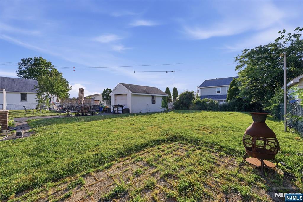 End your day to breathtaking sunsets and wide-open skies at 653 7th Avenue in Lyndhurst. Situated on an oversized and rarely available 65' x 125' lot (approximately 8,100 square feet), this property offers a unique opportunity for homeowners seeking space, privacy, and future potential. Whether you're looking for a move-in ready home or envisioning expanding and customizing over time, this property provides options that are increasingly difficult to find in Lyndhurst. The expansive backyard showcases beautiful open-sky views with no large trees obstructing the scenery, creating the perfect setting to enjoy stunning sunsets, entertain guests, or cultivate a flourishing garden. Inside, you'll find a bright and inviting layout featuring 4 bedrooms, 2 full bathrooms, and all smart appliances, Bespoke Samsung brand. Unlike many traditional cape-style homes, the second-floor bedrooms offer generous dimensions and functional living space rarely found in homes of this style. The home also features a one-car garage, driveway parking for up to five vehicles, and a high-ceiling basement with excellent potential to be finished into additional living space, a recreation room, home office, gym, or guest suite. Conveniently located near Lyndhurst's schools, parks, shopping, dining, and NYC transportation, this property combines suburban charm, exceptional outdoor space, and long-term value. Opportunities to own a lot of this size in Lyndhurst are few and far between.