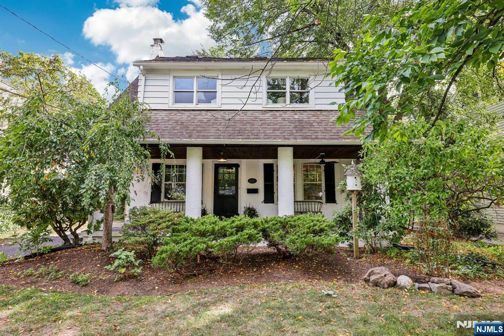 This fabulous colonial tucked in the heart of Ridgewood's sought after Somerville School district greets you with a wide open porch complete with fan and lighting, and shaded by mature trees! Inside is new 7" white oak flooring in the dining room, and living room with fireplace and new hearth. The chef's kitchen has new countertops, a six burner Viking stove with griddle and pot filler, a new Samsung Bespoke Smart Refrigerator, and new stainless steel d/w. The adjacent breakfast room's sliding doors lead onto a terrace and a nearby wisteria covered dining patio, both ideal for either formal or informal gatherings. Upstairs are gleaming restored hardwood floors and new wide plank flooring, and the oversized primary bedroom with four closets and built-in shelving, is ensuite. The additional bedrooms have plantation shutters, skylights, and custom closets. A finished third floor makes a wonderful family room which can be easily converted into a 4th bedroom. There's plenty of room for play in the lower level, or outside in the deep fenced private yard complete with gazebo and hammock area. The insulated and climate controlled garage has high end custom doors, new flooring, and a restored cupola. A new boiler, new WIFI controlled water filtration system, new driveway, and an underground sprinkler system make this the home you've been waiting for! Enjoy Ridgewood's award winning schools, vibrant downtown, and close proximity to transportation and shopping!