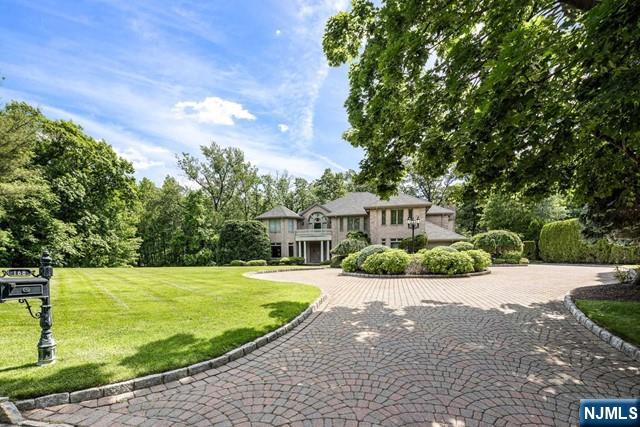 PRICE IMPROVEMENT! Located on one of Bergen County's most prestigious and sought after streets, this home is impeccable in every way. Designed for total privacy and lavish entertaining. Natural light floods the home and the sounds of nature surround the property from the tranquil pond. A gourmet chef's kitchen, complete with high end appliances and fireplace, overlooks pool and patio. The luxurious primary suite with separate sitting room with fireplace is the perfect place to unwind. Meticulously maintained, no detail overlooked. This is truly a special property. Please call Annitsa @ 201-406-3650 for more information