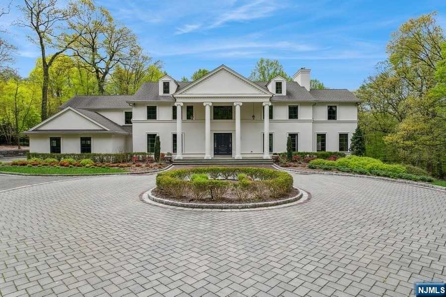 This luxury-class gated residence set on Very Private & Tranquil Cul de Sac in prestigious Alpine. 2+ park like acres & a central paved driveway offering perfect home for entertaining. A welcoming two story entrance foyer to banquet sized dining rm, formal living rm w/fpl to balcony to look out to lush property, library w/built-ins & fpl., chef's kitchen to the large patio w/built in outdoor kitchen, a sun filled breakfast rm to mud rm w/access to 3 car heated garage. Sun drenched family rm w/fpl and custom wet bar, palladium windows overlooking the private grounds. 2nd level has a spacious principal suite w/fpl and dressing rm with a Juliette balcony, two en suite bedrooms, and another two bedrooms w/Jack & Jill fbath and laundry, and side stairwell. Enjoy a lower level 10 seat home theater, fitness rm, hobby rm, w/fbath and rec rm access to stunning heated in ground pool with fully equipped cabana. Great community, excellent school systems, low taxes and only 11 miles from NYC