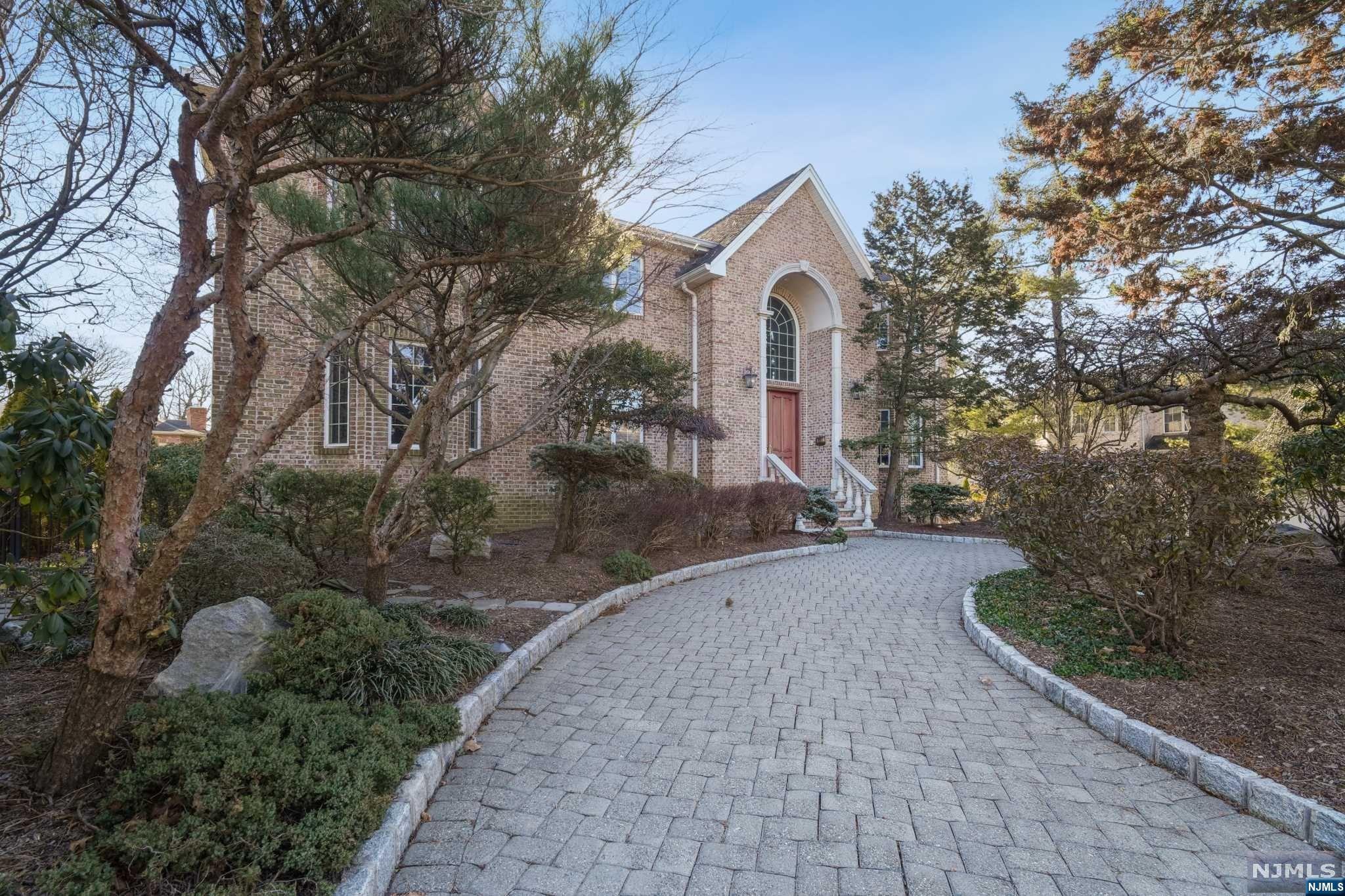 Discover this stunning brick colonial in Englewood Cliffs, NJ, where elegance and privacy converge. A front wrap driveway and lush landscaping set the stage for sophistication. This home features 6 bedrooms and 5 1/2 baths, including a convenient main floor bedroom with bath, ideal for guests. At the heart of the home is the dramatic 2-story great room, bathed in natural light, highlighting its elegant architecture. The stylish kitchen opens to a huge deck, perfect for entertaining, and flows into the dramatic family room, ensuring a seamless space for relaxation and socializing. The upper level houses the main bedroom with a luxurious en-suite bath, and 3 more bedrooms and 2 additional baths. The lower level boasts a versatile finished basement, complete with an additional bedroom and bath, offering flexibility for entertainment or personal use. This property is more than a home; it's a lifestyle choice, offering suburban tranquility with easy access to NYC.
