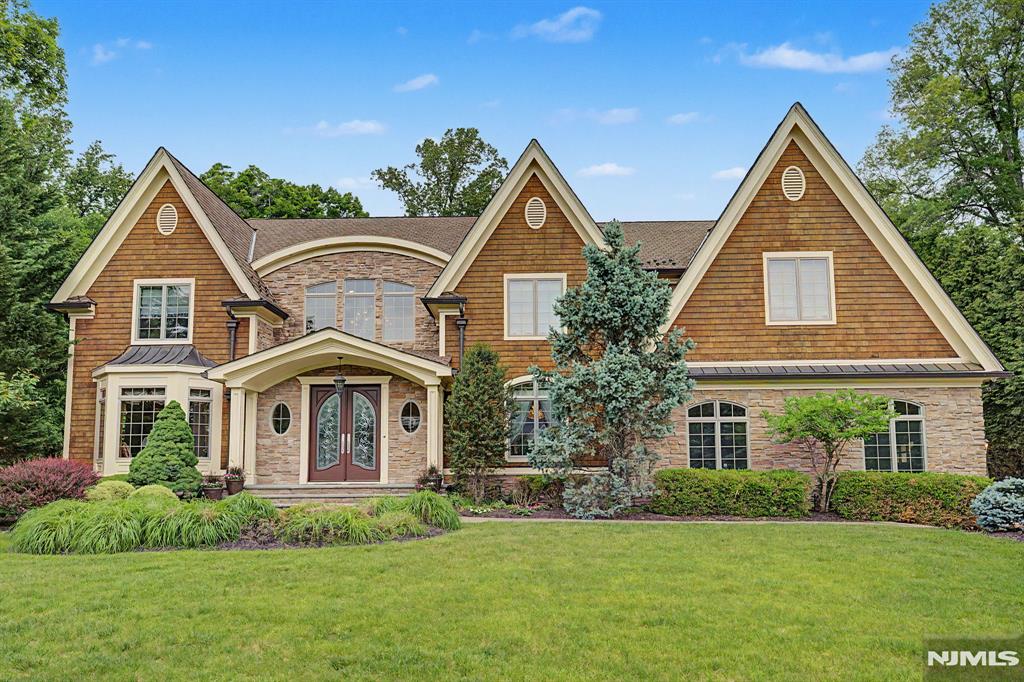 Step into this magnificent 6,750 square foot center hall colonial, where timeless elegance, modern functionality, and exceptional craftsmanship come together seamlessly. As you enter, you are greeted by the refined beauty of this home; featuring rich cherry wood elements, beautifully designed coffered ceilings and extensive architectural millwork. The heart of the home is a spectacular gourmet kitchen, designed to impress even the most discerning chef. showcasing two center islands, premium stainless steel appliances, a spacious sun filled breakfast area, plus radiant heated floors. The kitchen is complemented by a beautifully appointed scullery, providing additional prep space, storage and seamless entertaining functionality. Complementing the main living spaces are a first floor bedroom ensuite, Living Room, Great Room with 3 sided fireplace, Dining Room, 2nd Family Room/Fpl. plus 2 powder rooms, and a well-appointed mudroom with direct access to the attached oversized heated 3 car garage, with car lift. 2nd floor features a primary ensuite, offering a sitting room, fireplace, exquisite bath, dressing area plus his/hers walk in closets. 4 additional bdrms , 2 bths, plus laundry room. 3rd Level is a versatile space, perfect for a movie room or recreational rooms. Bsmt is part unfinished with 10' ceilings ready to be transformed into your dream space. Outside, the homeâ€™s tranquil patios are complemented by a stunning waterfall and beautiful landscaping, surrounded by nature