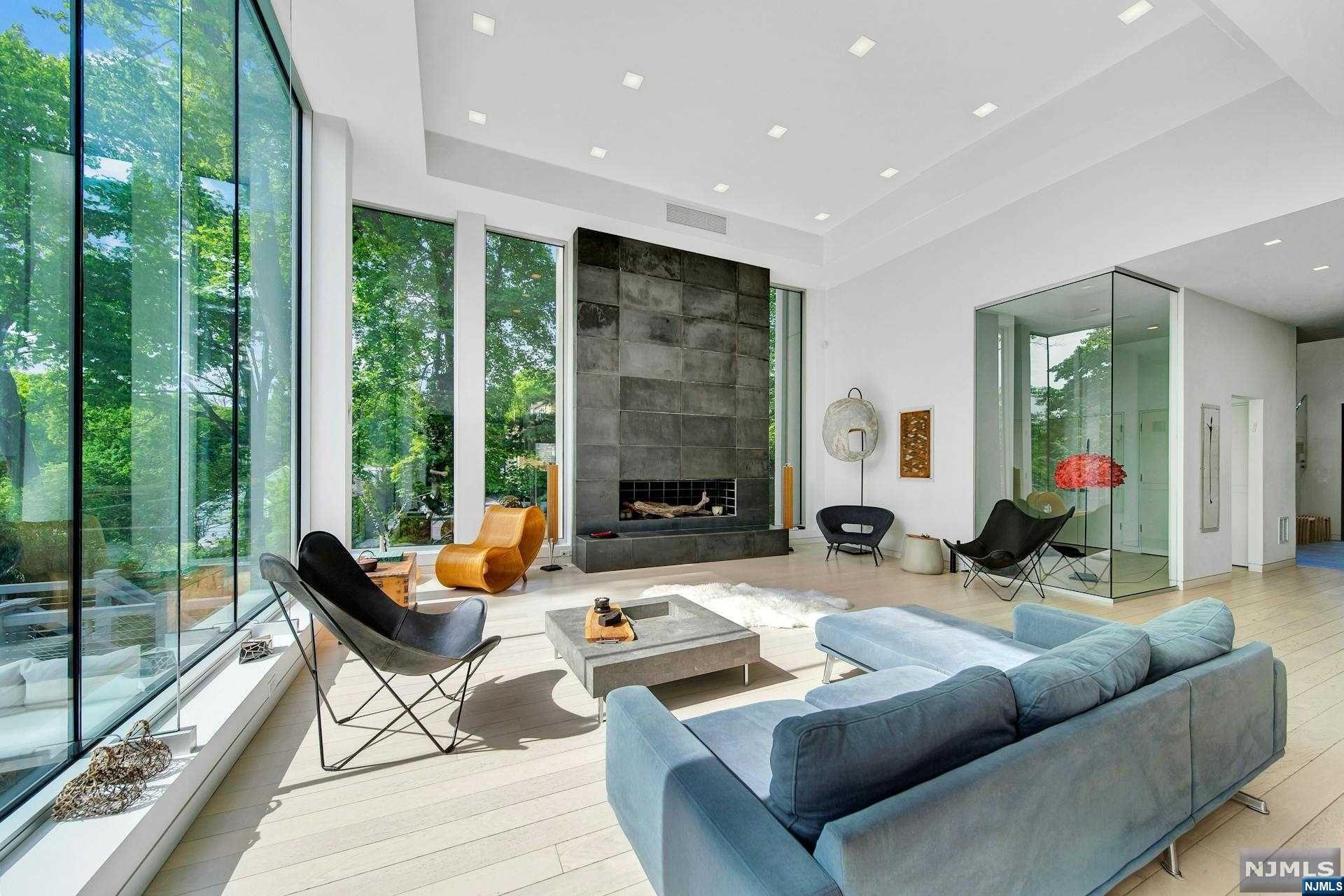 This extraordinary, high-end custom home is inspired by Bauhaus Principles. The remarkable residence seamlessly integrates art, craftsmanship, and smart technology in its design. Boasting five bedrooms and six baths, it showcases a spacious living area enveloped in floor-to-ceiling windows, complemented by a FPL for added warmth. The Wolf kitchen is equipped with top-of-the-line amenities including a cooktop, dual ovens, warming drawer, Sub Zero refrigerator, two Bosch dishwashers, silestone quartz countertops, and Neff cabinetry. A prep kitchen with striking blue cabinets,dishwasher, U-Line ice maker,pantry, laundry facilities, and mudroom. A bedroom with a full bath completes 1st floor. Upstairs, four en-suite bedrooms with custom closets await, along with a generous family room featuring a Gas FPL and breathtaking treetop vistas. The lower level presents an expansive walk-out basement with a full bath. Heated paver driveway, a heated three-car garage,full house generator.