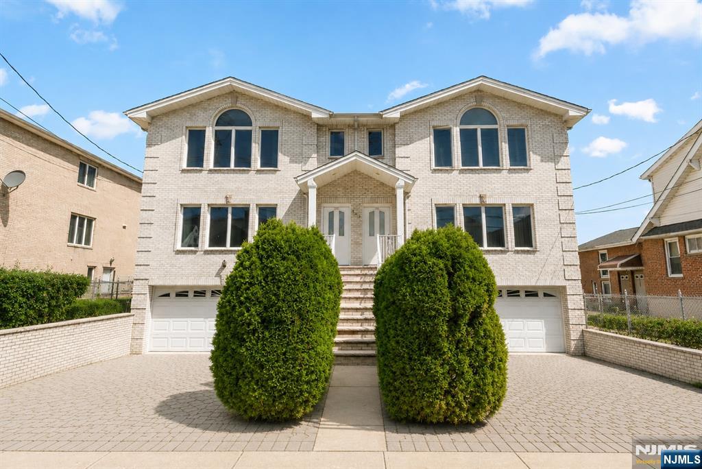 Well maintained 3BD 3.5 BTH home is in a prime location in Fort Lee. This all brick home features a wide driveway with pavers, eye-catching landscaping, oversized garage, and beautiful maple floors throughout the home. Kitchen includes recently updated stainless steel appliances, an eat-in dining area, and sliding door to the balcony with space for a BBQ. Upstairs two bedrooms share a clean and bright hallway bathroom. Master bedroom features expansive windows letting in all the sunlight, high ceilings, and two walk-in closets with plenty of storage space. Ground floor includes storage/office/living space, access to the garage, W/D, and a full bath. The spacious backyard features beautiful foliage. This home is in a prime location with ease of access to both Fort Lee and Cliffside park restaurants, shopping and more. Excellent school district, specifically elementary school #4. Public transportation is only a few steps away with multiple options for getting into NYC.