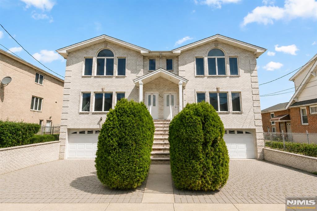Well maintained 3BD 3.5 BTH home is in a prime location in Fort Lee. This all brick home features a wide driveway with pavers, eye-catching landscaping, oversized garage, and beautiful maple floors throughout the home. Kitchen includes recently updated stainless steel appliances, an eat-in dining area, and sliding door to the balcony with space for a BBQ. Upstairs two bedrooms share a clean and bright hallway bathroom. Master bedroom features expansive windows letting in all the sunlight, high ceilings, and two walk-in closets with plenty of storage space. Ground floor includes storage/office/living space, access to the garage, W/D, and a full bath. The spacious backyard features beautiful foliage. This home is in a prime location with ease of access to both Fort Lee and Cliffside park restaurants, shopping and more. Excellent school district, specifically elementary school #4. Public transportation is only a few steps away with multiple options for getting into NYC.