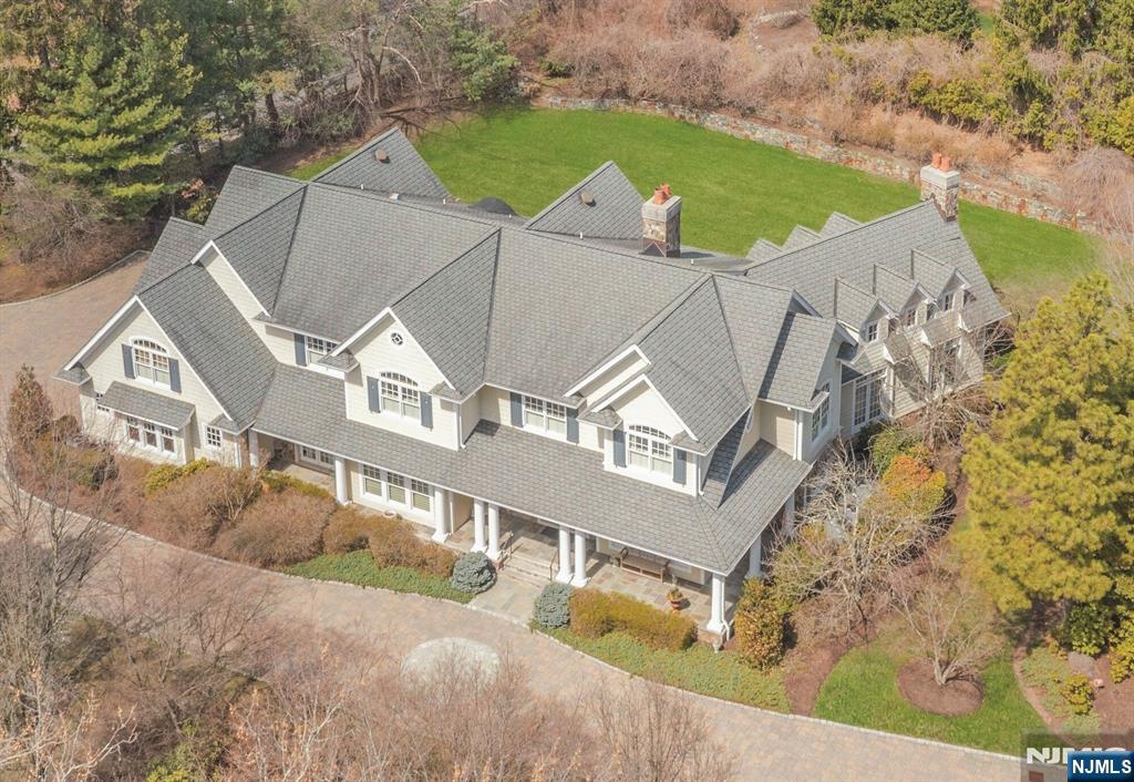 This 8200+ sf country farmhouse is situated on a picturesque acre. The design is unique and has great features throughout. 3 fireplaces, one in the large foyer entry, plus the den & great room. The expansive dining room is beautiful & the vaulted great room has 6 dormered windows, built-ins surrounding the stone fireplace and a wet bar opening to the den/fpl & built-ins. There is a bedroom/bath that also doubles as an office, and a custom country kitchen with large island & high-end appliances & breakfast area. A full bath and formal powder room & laundry complete the 1st floor. The 2nd floor primary suite offers a sitting room, a boutique closet & cedar closet, large bath with separate shower, jacuzzi & vanity area. Four bedrooms, 3 baths, 2nd laundry, and large media room. Semi-finished lower level with bath and utilities. 3 car garage, and patios. Private acre with great supporting value.