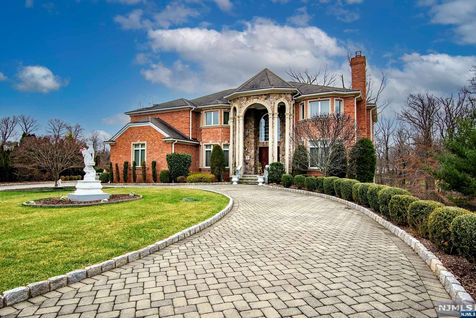 Welcome to this stunning, all brick colonial home nestled on 2.76 acres of beautiful undulating land and mature landscaping. The home features very large rooms with soaring ceilings throughout the entry area and great room. This very open floor plan on the first level offers an oversized kitchen with an attached sunroom, breakfast area and den that is ideal for large family gatherings. A living room, powder room, laundry and library finish out the first level. 4 additional bedrooms 2 full bathrooms and huge loft sitting area make up the second level. A full finished lower level with full kitchen and walk out stone terrace are a great place for kids and adults alike. In addition, the first level has two stone terraces with amazing views of the secluded lot. 3 car garage and Gazebo and full stone terrace. It is a true must see.