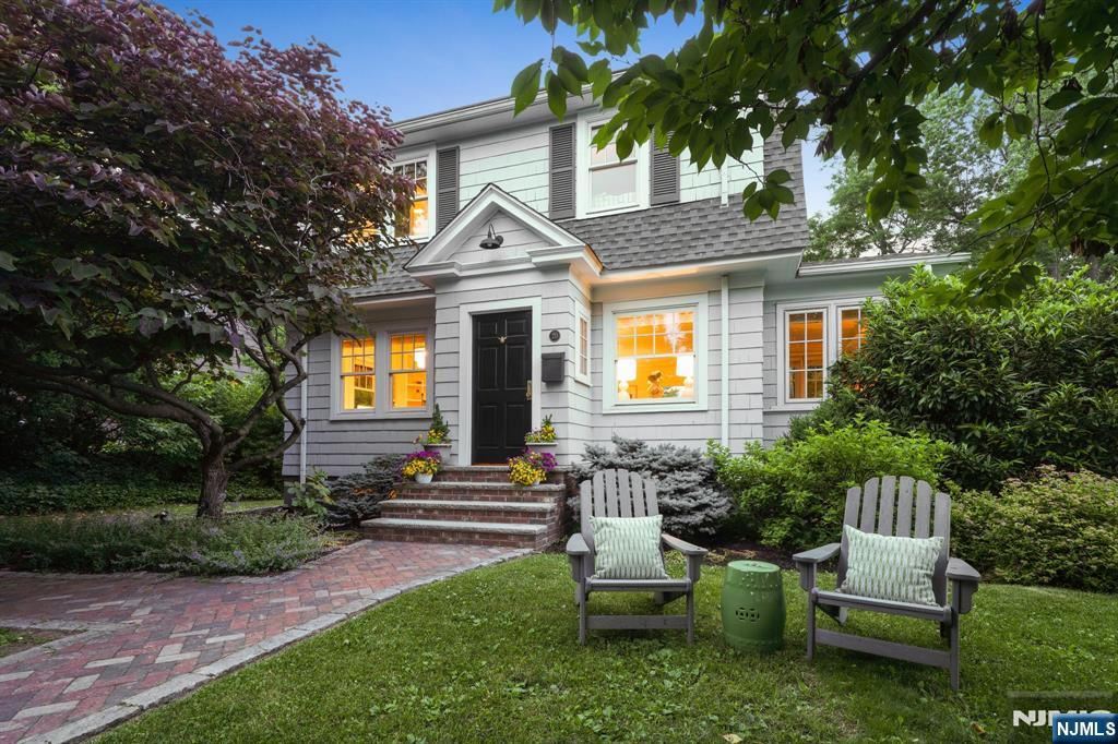 Enjoy this updated Colonial on an oversized, lushly landscaped lot on one of Montclair's most desirable tree-lined streets with a fun neighborhood vibe, just moments from NYC-bound trains and everything Montclair has to offer. Sunlight streams through new windows illuminating bright, inviting interiors w/ newly installed hardwood floors through out the first level. The living room is anchored by a cozy gas fireplace, while the formal dining room w/ custom built-ins opens to an English-inspired kitchen featuring quartz counters, s/s appliances, a herringbone floor, distinctive deVOL hardware & a breakfast bar. Plus, a charming sunroom provides a perfect place for a home office, reading nook or creative retreat. The second floor offers a serene primary suite w/ a private en-suite bath. Two additional bedrooms & an updated bath complete this level. A walk-up attic presents exciting potential for the future. The finished lower level adds valuable living space ideal for a rec room or home gym & laundry area. Outside, the property truly shines. A new custom bluestone patio creates the perfect setting for outdoor dining, entertaining, or relaxing under the stars. Tucked away at the rear of the property, a charming detached cabin offers endless possibilities as a yoga studio, game room, home office, or peaceful retreat. Combining timeless charm and thoughtful updates this home offers the perfect blend of character, comfort, and lifestyle. Welcome Home!