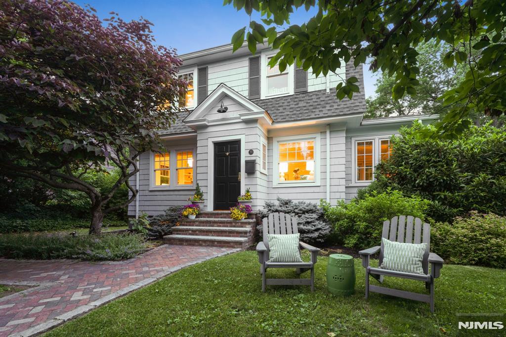 Enjoy this updated Colonial on an oversized, lushly landscaped lot on one of Montclair's most desirable tree-lined streets with a fun neighborhood vibe, just moments from NYC-bound trains and everything Montclair has to offer. Sunlight streams through new windows illuminating bright, inviting interiors w/ newly installed hardwood floors through out the first level. The living room is anchored by a cozy gas fireplace, while the formal dining room w/ custom built-ins opens to an English-inspired kitchen featuring quartz counters, s/s appliances, a herringbone floor, distinctive deVOL hardware & a breakfast bar. Plus, a charming sunroom provides a perfect place for a home office, reading nook or creative retreat. The second floor offers a serene primary suite w/ a private en-suite bath. Two additional bedrooms & an updated bath complete this level. A walk-up attic presents exciting potential for the future. The finished lower level adds valuable living space ideal for a rec room or home gym & laundry area. Outside, the property truly shines. A new custom bluestone patio creates the perfect setting for outdoor dining, entertaining, or relaxing under the stars. Tucked away at the rear of the property, a charming detached cabin offers endless possibilities as a yoga studio, game room, home office, or peaceful retreat. Combining timeless charm and thoughtful updates this home offers the perfect blend of character, comfort, and lifestyle. Welcome Home!