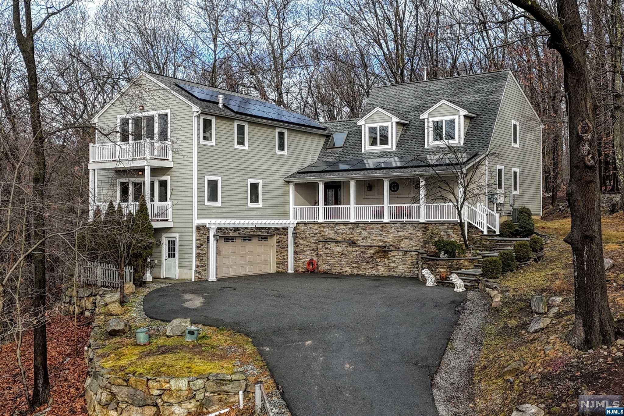 THIS IS A UNICORN! GORGEOUS CUSTOM HOME only 14 years old WITH MOUNTAIN VIEWS and EASY COMMUTE TO NEW YORK CITY! HUGE FRONT PORCH AND MULTIPLE BALCONIES AND DECK! SOARING HIGH CEILINGS AND TRUE OPEN CONCEPT greet you and pull you right in like a warm hug! ENTRANCE FOYER, LIVING ROOM, DINING ROOM, KITCHEN ARE ALL OPEN CONCEPT IN ONE BIG BEAUTIFUL GREAT ROOM w/ multiple French Doors inviting you to the deck! Walls of Windows! 2 PRIMARY SUITES- One on the first floor, one on the 2nd floor! This is a True Custom Build sitting on 1.97 Acres backing up to Park Land! 3 Gas Fireplaces located in GREAT ROOM AND BOTH PRIMARY SUITES! 2nd Fl Primary features a Juliet Balcony to greet the day! Wait til you see the BUTLERS PANTRY plus an additional Pantry! Family Room on First Floor plus another in the loft on 2nd Floor! Exterior Custom STONE WORK! Solar Panels to reduce the cost of owning this GEM! This is a must see! You will never want to leave!