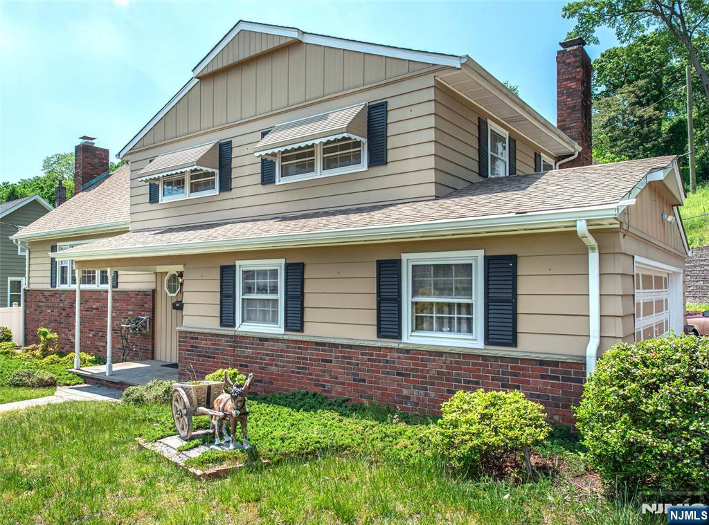 First time offered - custom built, spacious 4 bedroom home set in one of Haledon's premier locations. NYC views from 4th bedroom. Quiet neighborhood yet minutes to major highways, stores and shopping. Easy NYC commute. Wood floors. Newer roof. All public utilities. An abundance of closet space throughout home. Basement, heated two car garage, front porch, rear patio with terraces and storage shed. Spacious eat-in kitchen, formal dining room, formal living room with fireplace. Family room with fireplace, new flooring throughout to large entry foyer with double closet. Elegant primary suite with primary bath, walk-in closet and additional closet. Two additional bedrooms and main bath complete the second floor. Third floor offers private fourth bedroom with plumbing for third full bath. Partially finished basement with recreation area, laundry and storage. Turn this house into your dream home with plenty of space inside and out to make it your own! Minutes to William Paterson University and Passaic County Technical Institute Stem Academy.