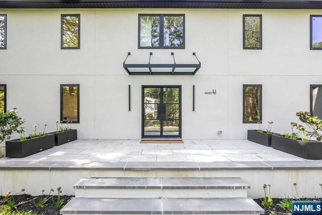 Presented by Bahr Rapaport-The Rapaport Group 9178481784.Situated on half an acre in the prestigious East Hill of Tenafly, this approximately 6200 sq. ft. residence offers luxurious living with 6 bedrooms and 5 full baths. The bright and open layout features a custom gourmet kitchen with Thermador appliances, a pantry and a wine bar. Enjoy a pre-wired movie theater and a dedicated gym room for entertainment and fitness. The first floor includes a versatile bedroom/cabana, ideal for guests or a private retreat.A seamless indoor-outdoor flow is elevated with a covered patio and a gunite heated pool. The home is generator-ready and energy-efficient, boasting dry cell foam insulation. Owner holds NJ real estate license.