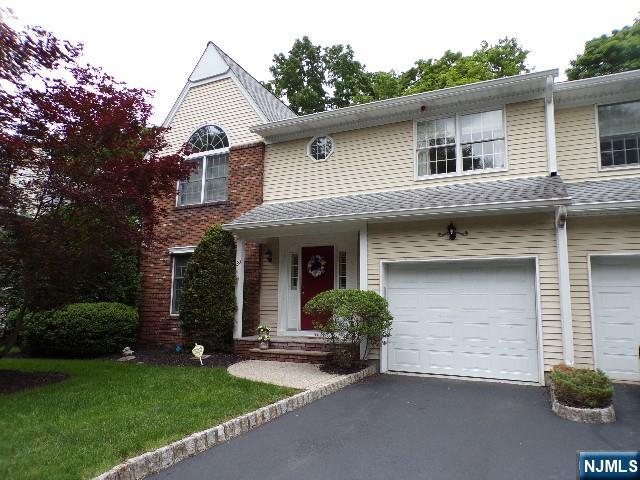 Well maintained End Unit Town home in sought after Ridgewood. Gracious 2 story entry foyer opens to the formal living room with wood burning fireplace, formal dining room with sliding glass door to a private deck. The sun drenched kitchen with breakfast area, the powder room, mudroom and laundry area complete the 1st floor. Upstairs features 2 spacious bedrooms each with a bath. The Primary suite has a cathedral ceiling, dressing area, walk in closet and bath with jacuzzi, double vanity and skylight. The second bedroom offers 2 double closets and a bath with shower over tub. The lower level has a large finished Rec Room, recessed lighting and plenty of storage. Hardwood floors, central A/C. Convenient access to NYC transportation.